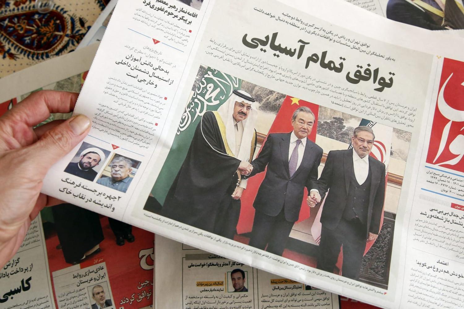 An Iranian newspaper reporting news of the China-brokered deal between Iran and Saudi Arabia to restore ties, signed in Beijing on 10 March (Atta Kenare/AFP via Getty Images)