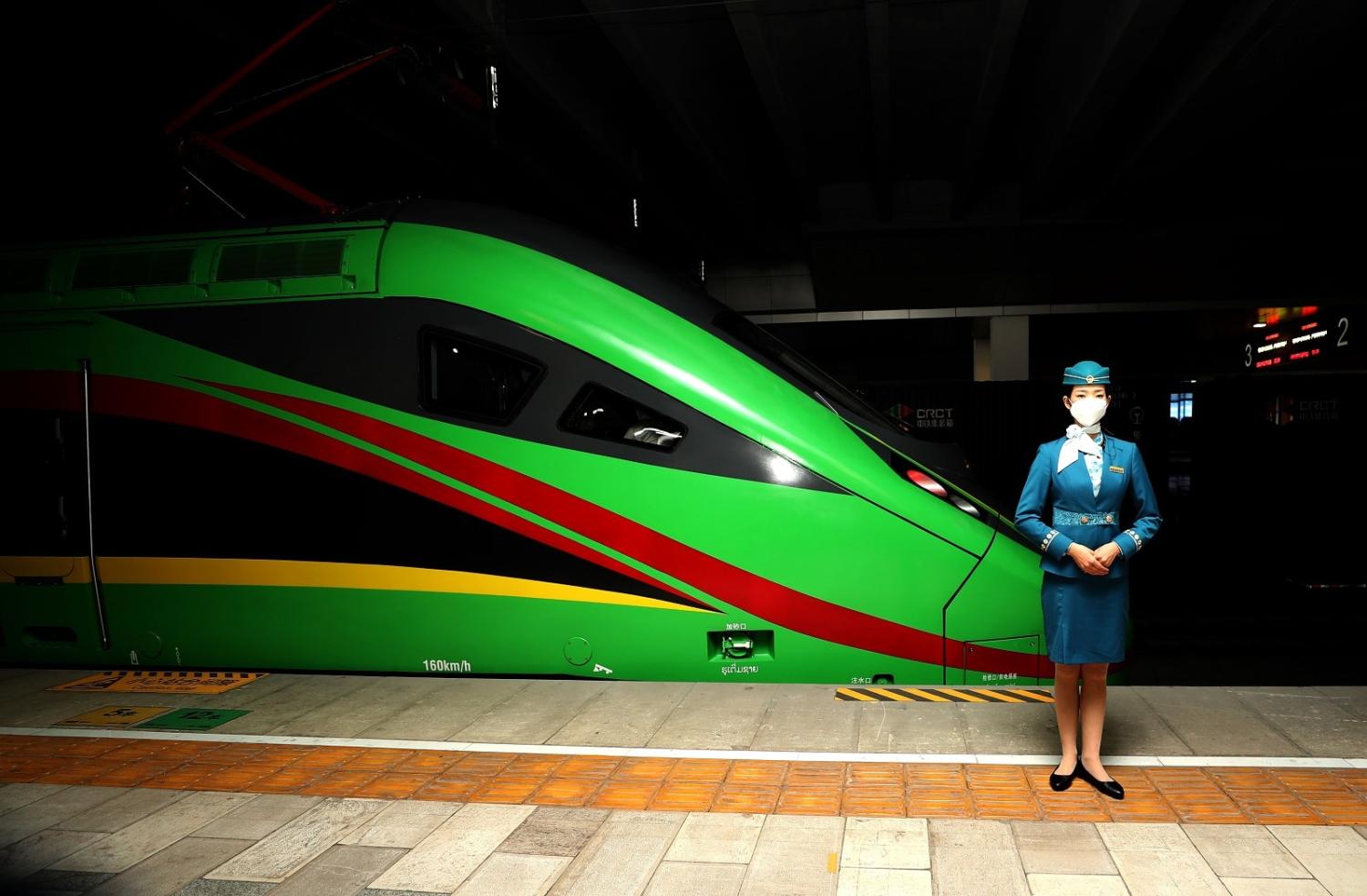 A train worker poses before the first regular service of the Chinese-Laos railway (Gun Yu/Future Publishing via Getty Images)