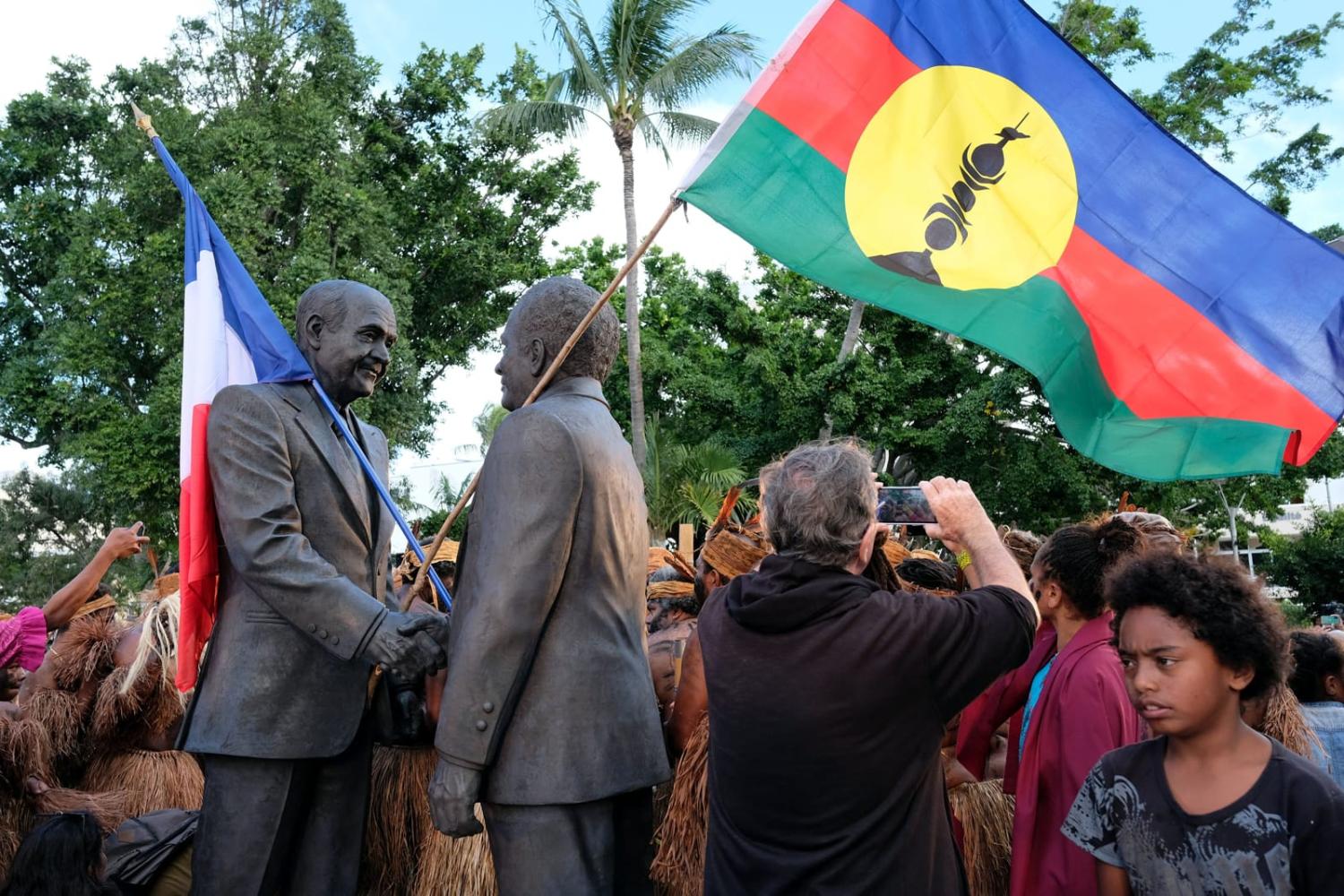 A statue of New Caledonia’s anti-independence leader Jacques Lafleur, left, shaking hands with Kanak independence movement leader Jean-Marie Tjibaou, right, under agreements that eventually led to the 1998 Nouméa Accord (Theo Rouby/AFP via Getty Images)
