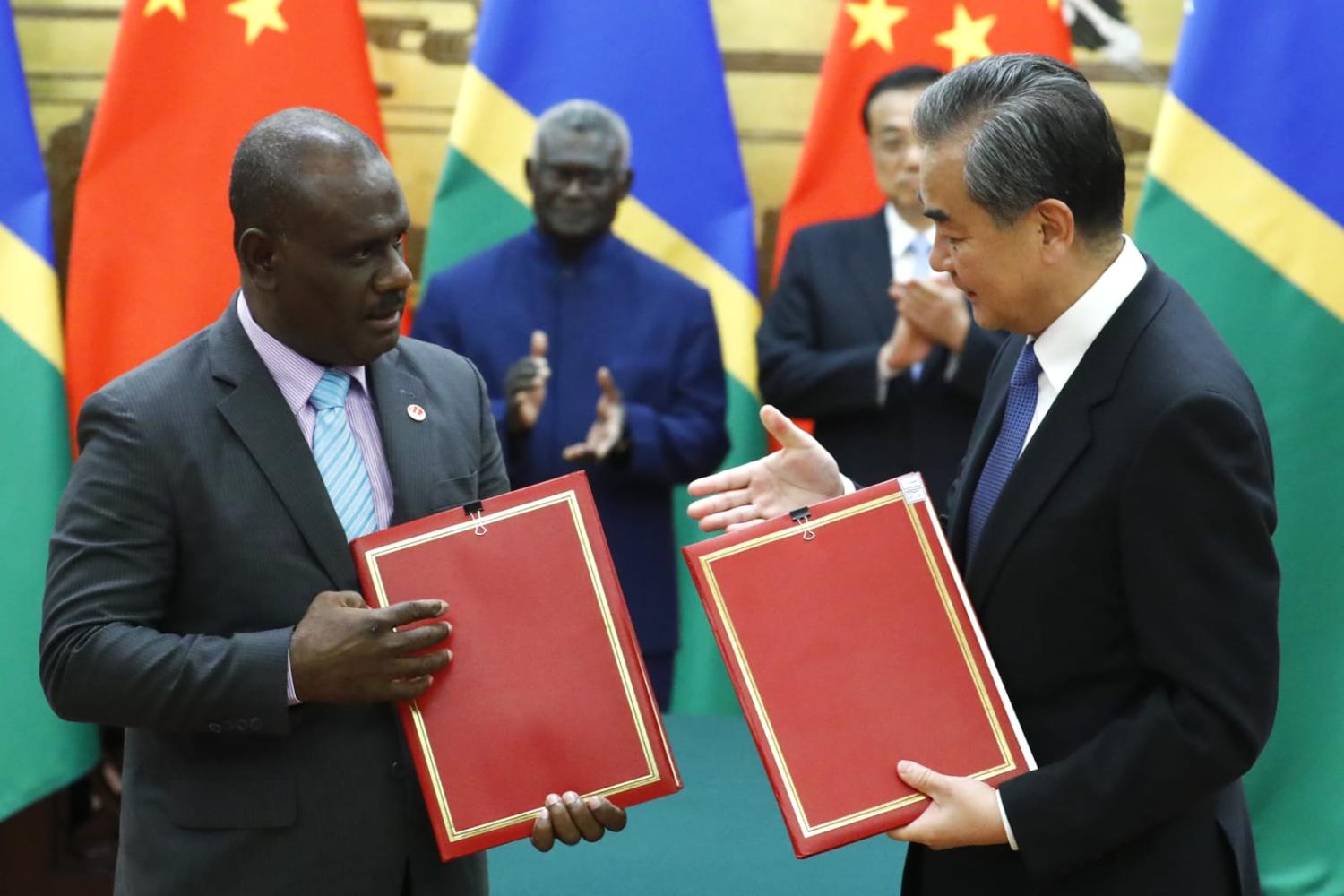China’s Foreign Minister Wang Yi (right) with then Solomon Islands counterpart Jeremiah Manele in 2019 following the establishment of diplomatic relations (Thomas Peter via AFP/Getty Images)