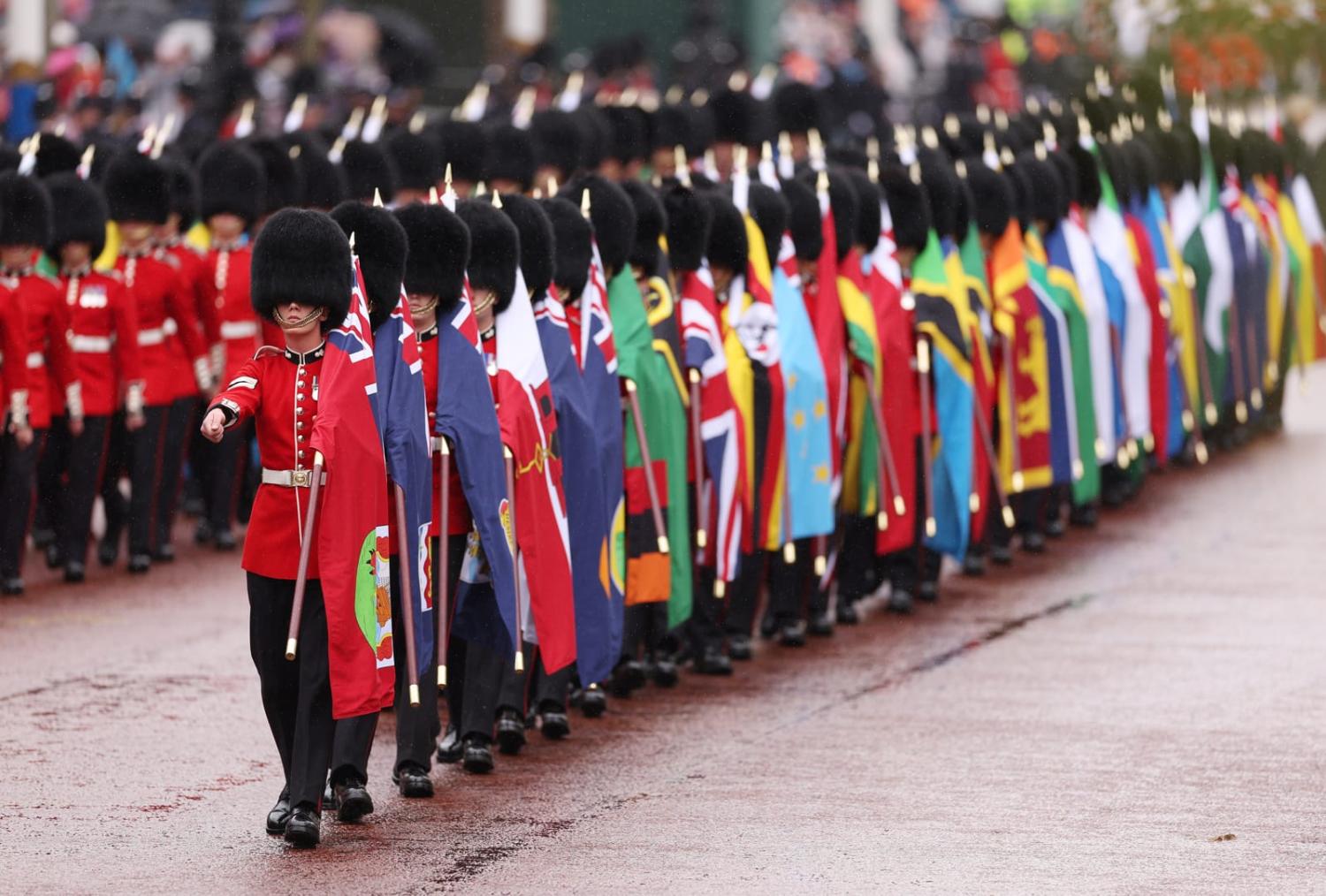 Foot guards carrying the flags of Commonwealth nations during the coronation ceremony of King Charles III and Queen Camilla  (Richard Heathcote via Getty Images)