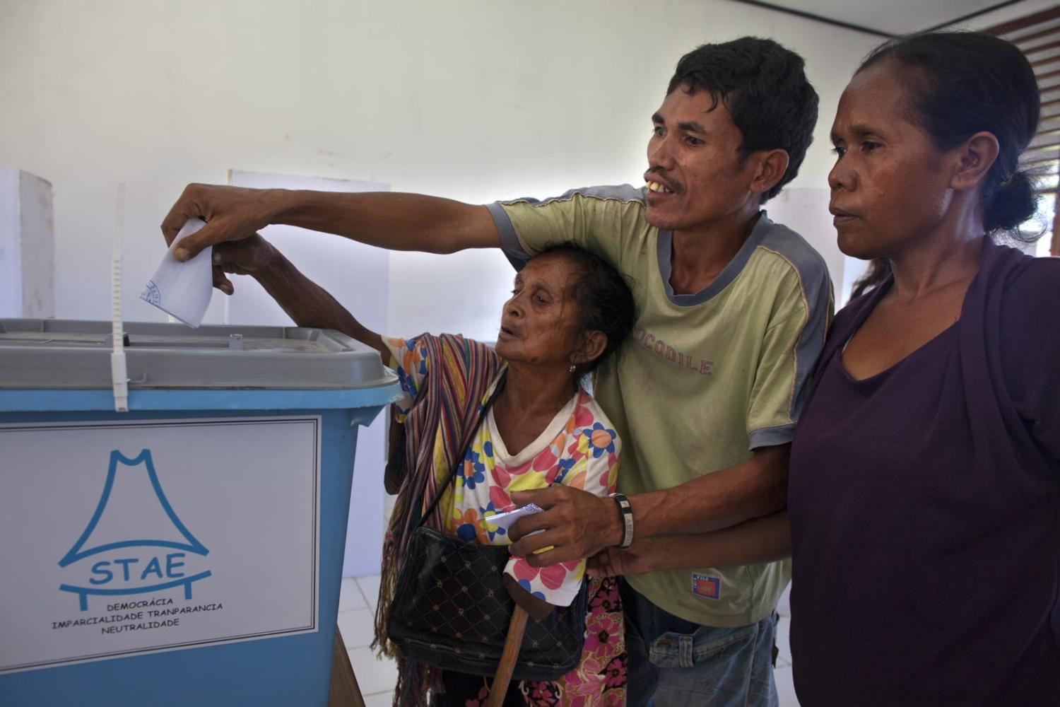 A woman assisted to vote by her family in 2012 Timor-Leste elections (Paula Bronstein/Getty Images)