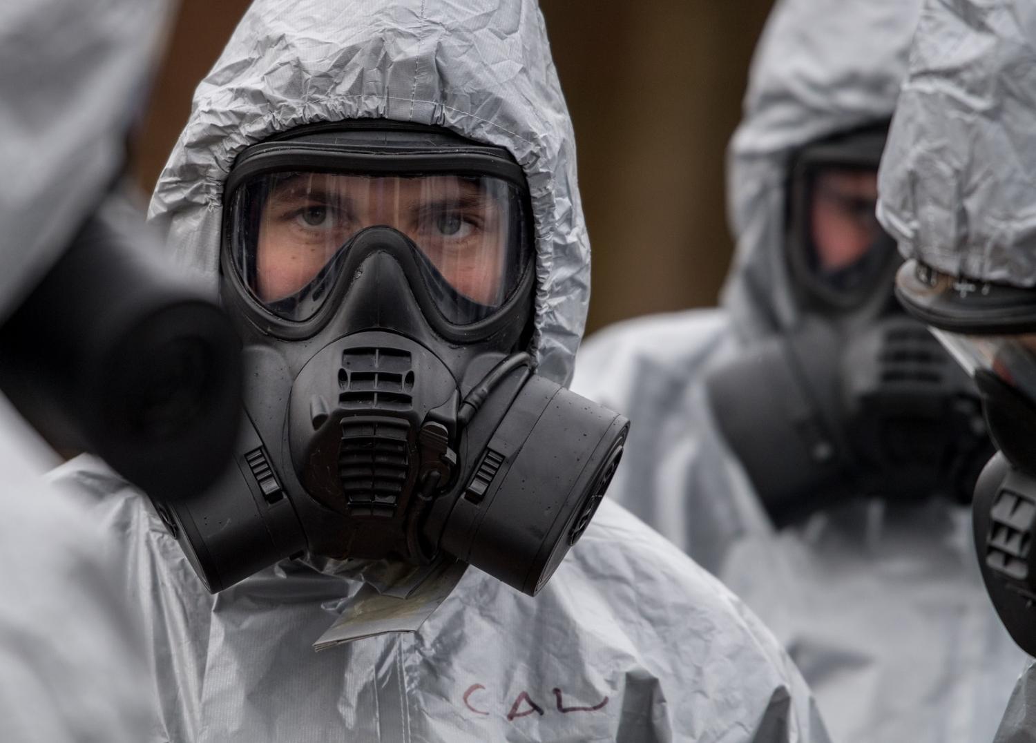 Military personnel wear protective suits as they investigate the poisoning of Sergei Skripal on 11 March 2018 in Salisbury, England (Chris J Ratcliffe/Getty Images)