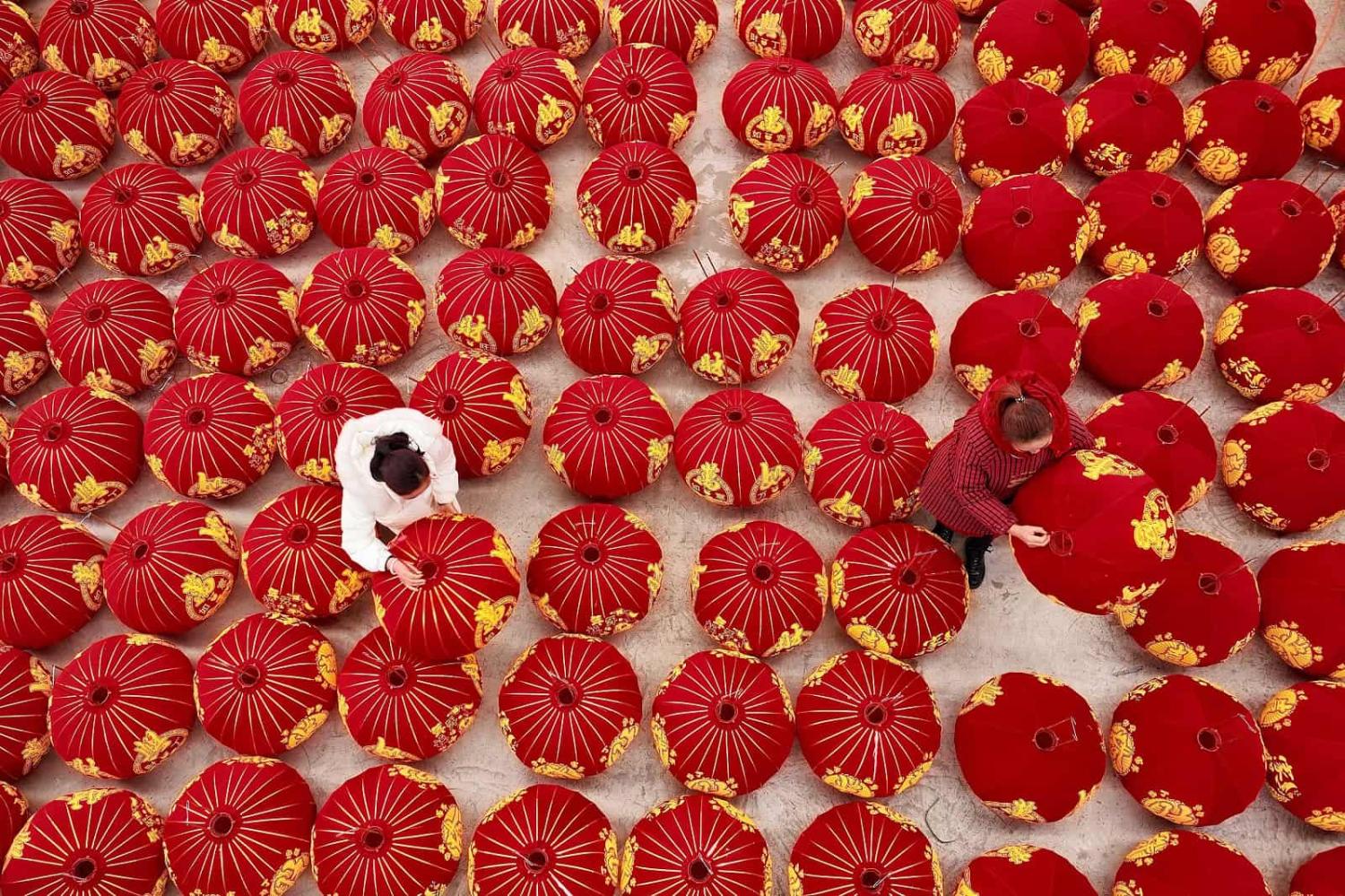 Australians see China as both an economic partner and a security threat. A worker produces red lanterns ahead of New Year's Day in Danzhai, China (STR/AFP via Getty Images)