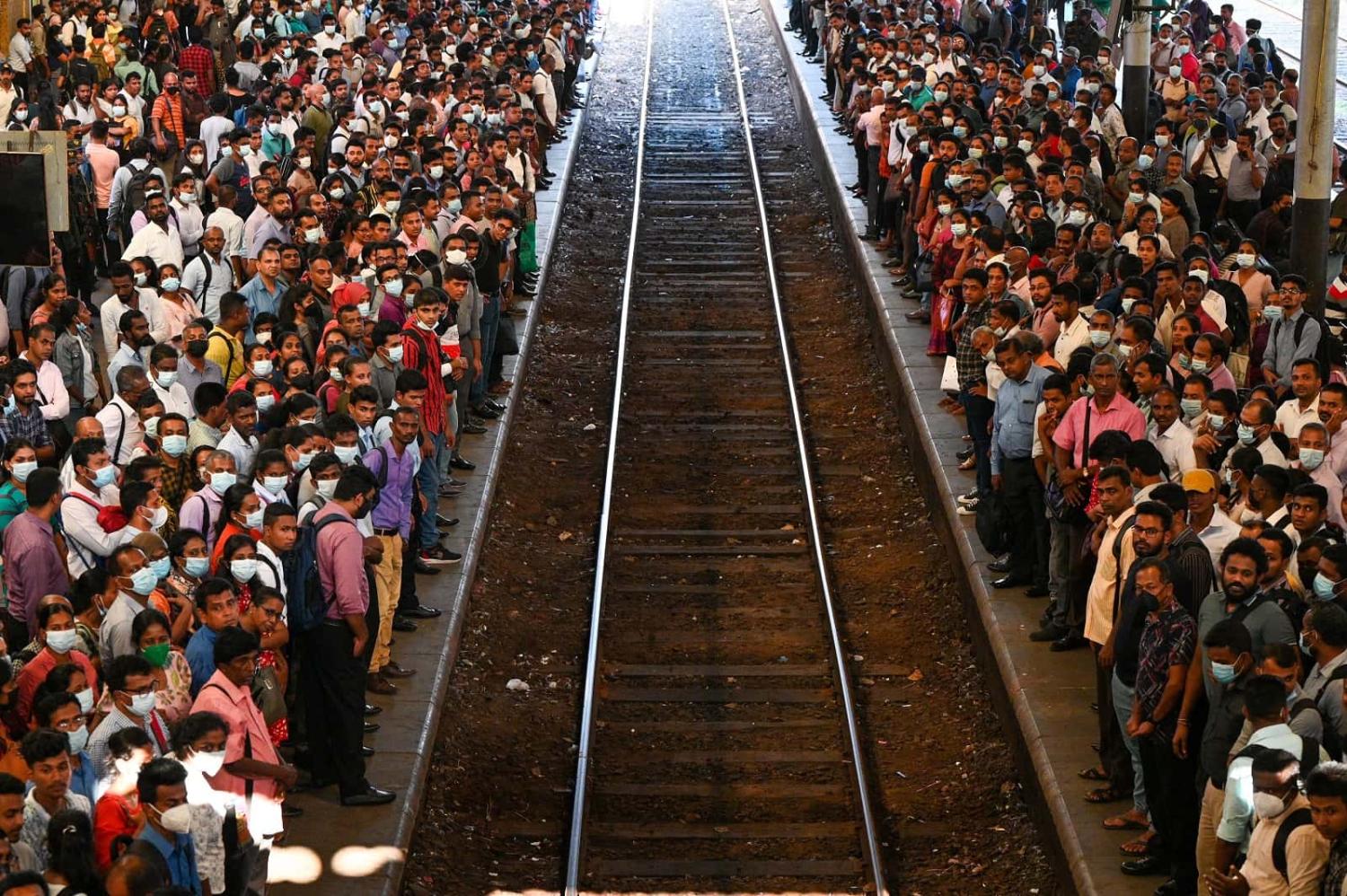 Commuters wait to board a train at the Fort railway station during a nationwide strike in Colombo on 15 March 2023 (Ishara S. Kodikara/AFP via Getty Images)