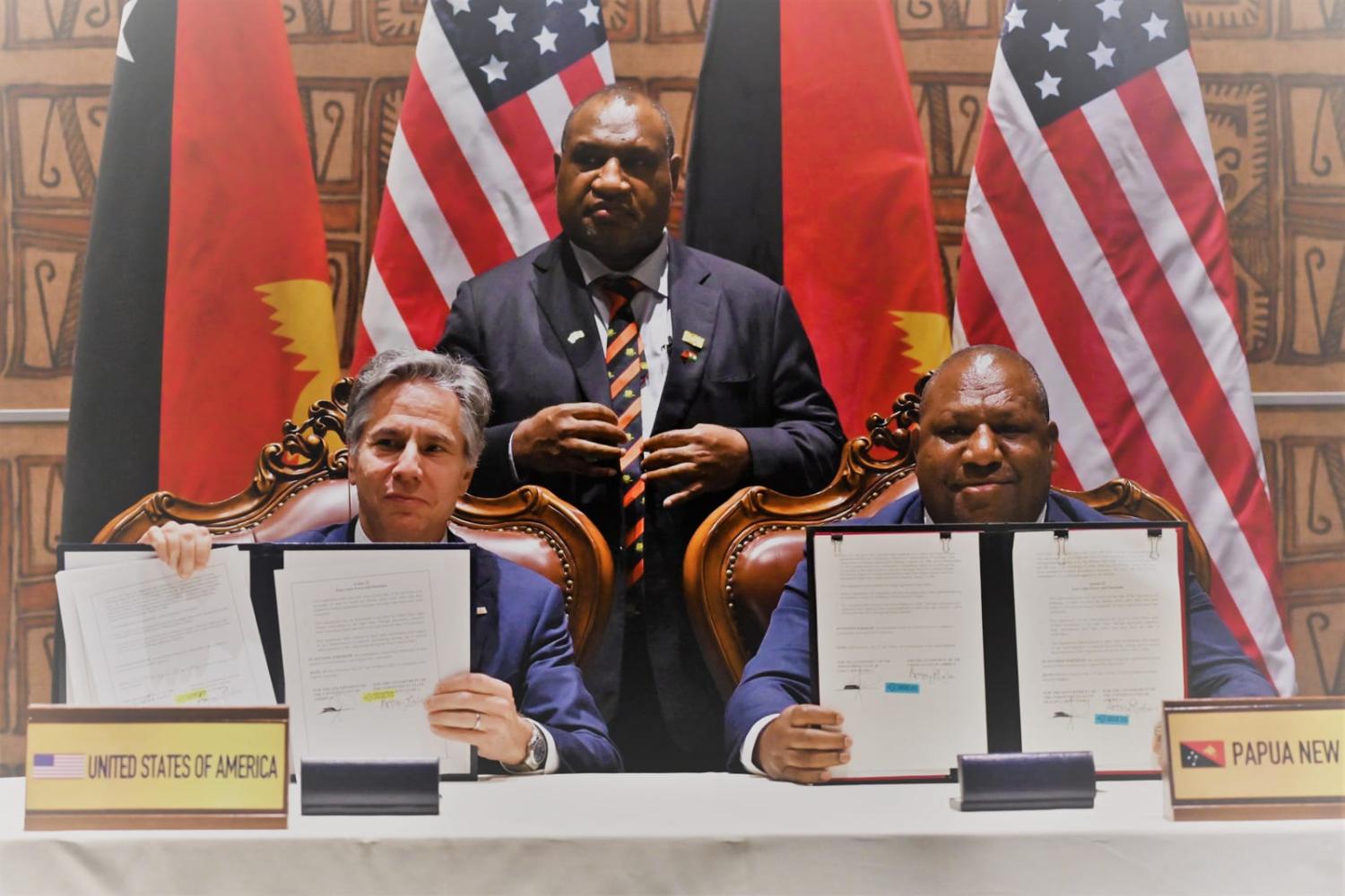 Papua New Guinea’s Prime Minister James Marape looks on as US Secretary of State Antony Blinken, left, and PNG Defence Minister Win Bakri Daki sign a security agreement in May (Adek Berry/AFP via Getty Images)