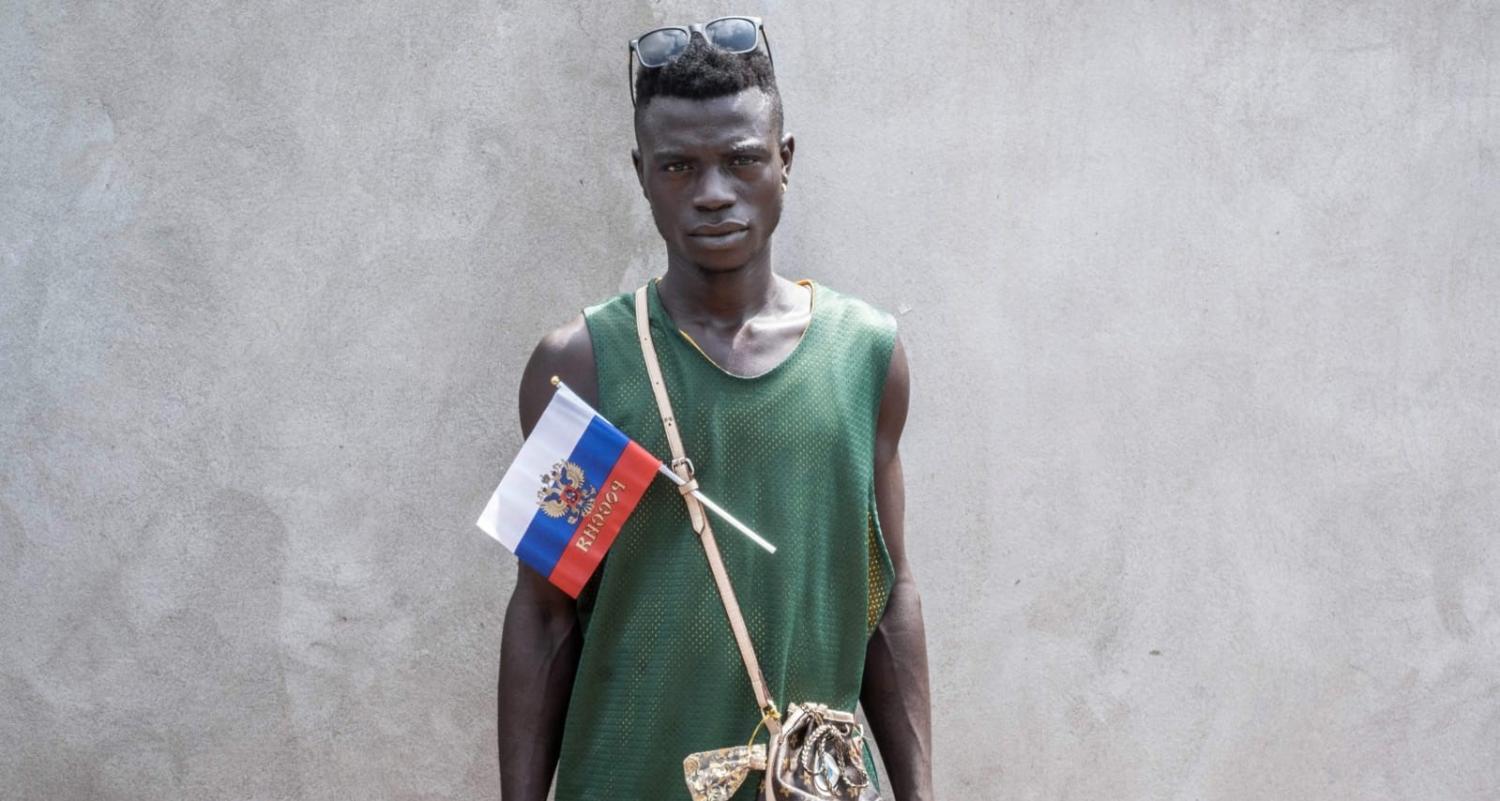 A demonstrator with a Russian flag and emblem poses in Bangui in March during a march in support of a Russian presence in the Central African Republic (Barbara Debout/AFP via Getty Images)