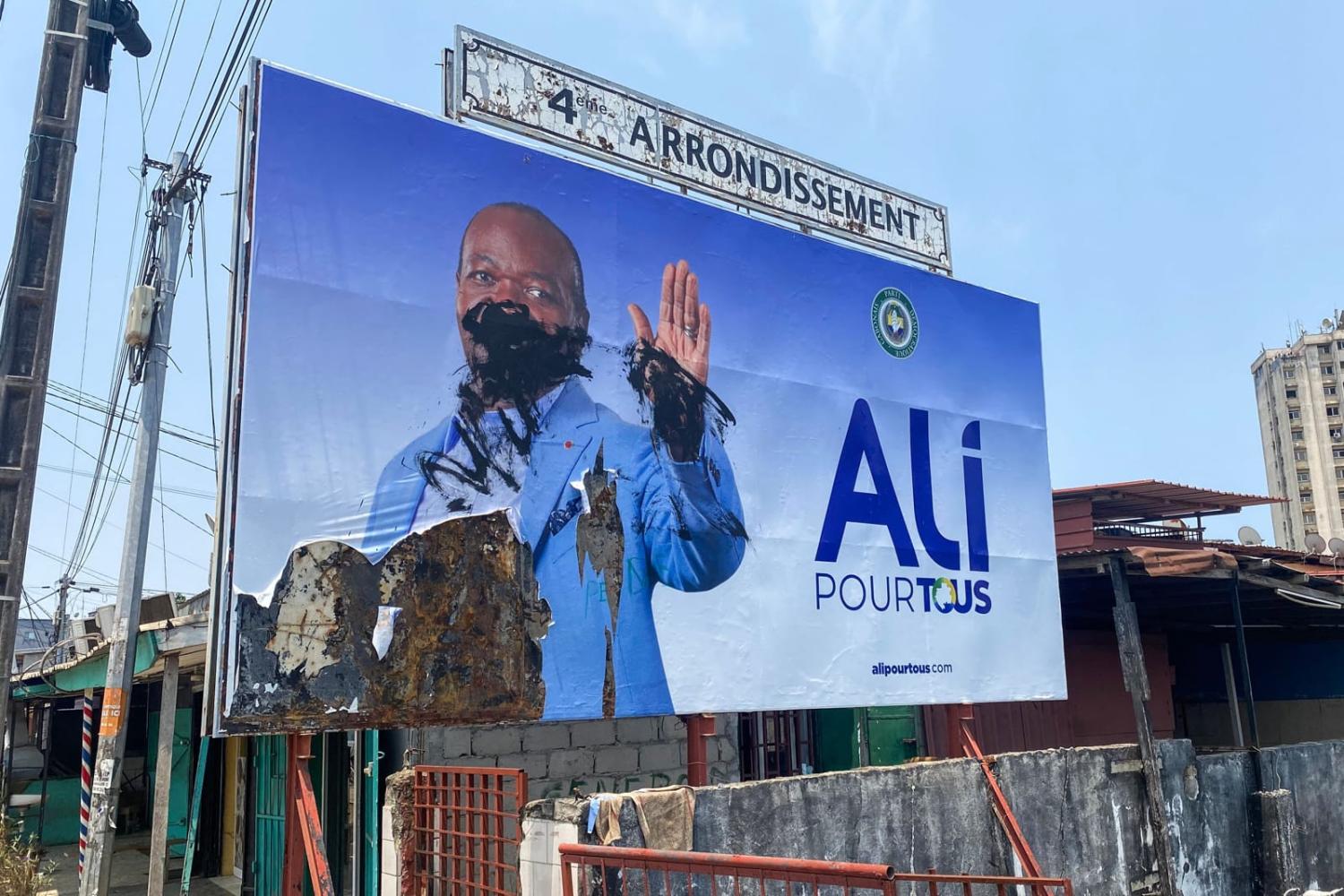A defaced campaign billboard of ousted Gabon President Ali Bongo Ondimba in Libreville following the coup last week (AFP via Getty Images)