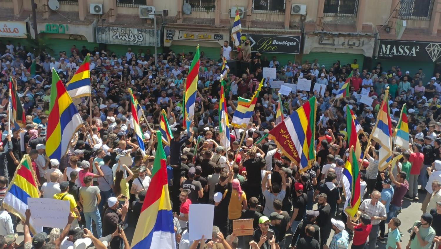 People gather to protest against Bashar al-Assad regime in Al-Suwayda, Syria on 25 August (Gayyas El Cebel/Anadolu Agency via Getty Images)