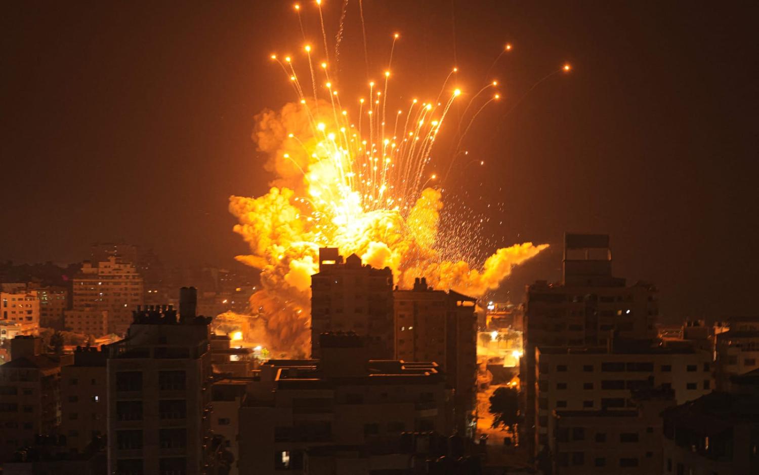 A missile explodes in Gaza City during an Israeli air strike 8 October following a Hamas incursion into Israel (Mahmud Hams/AFP via Getty Images)
