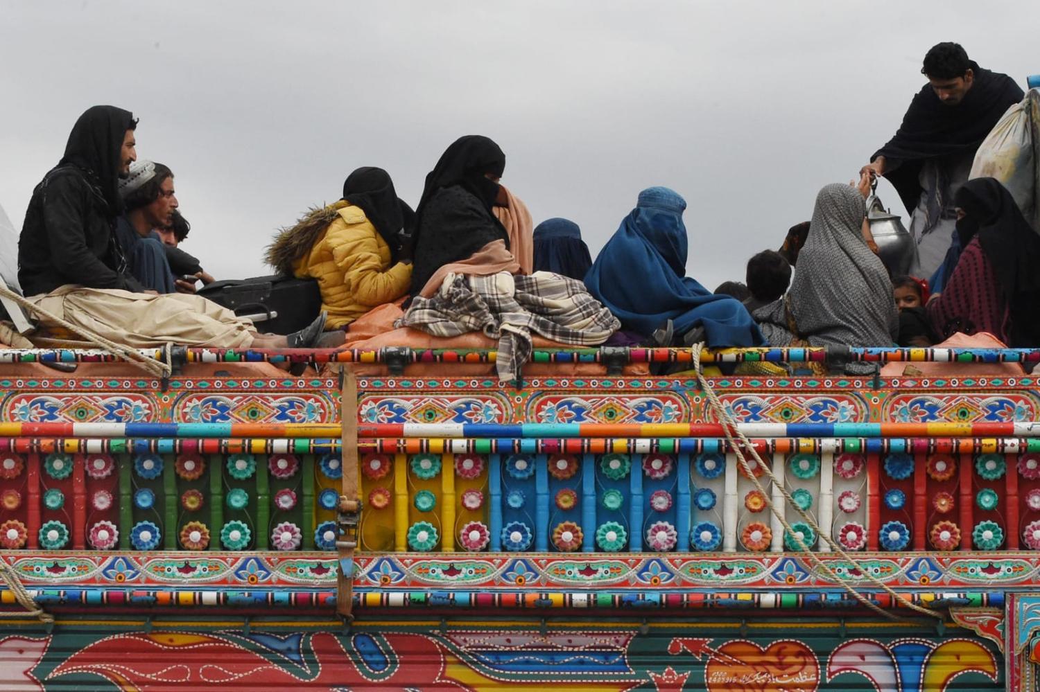 Afghan refugees arrive on a truck to cross the Pakistan-Afghanistan border in Chaman on 7 November after Pakistan ordered 1.7 million people to leave or face arrest and deportation (Banaras Khan/AFP via Getty Images)