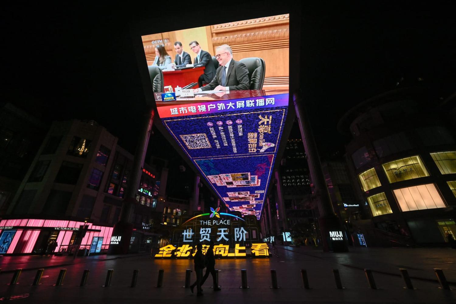 A giant screen outside a shopping mall shows news coverage of Australia's Prime Minister Anthony Albanese meetings in Beijing on 7 November 2023 (Pedro Pardo/AFP via Getty Images)