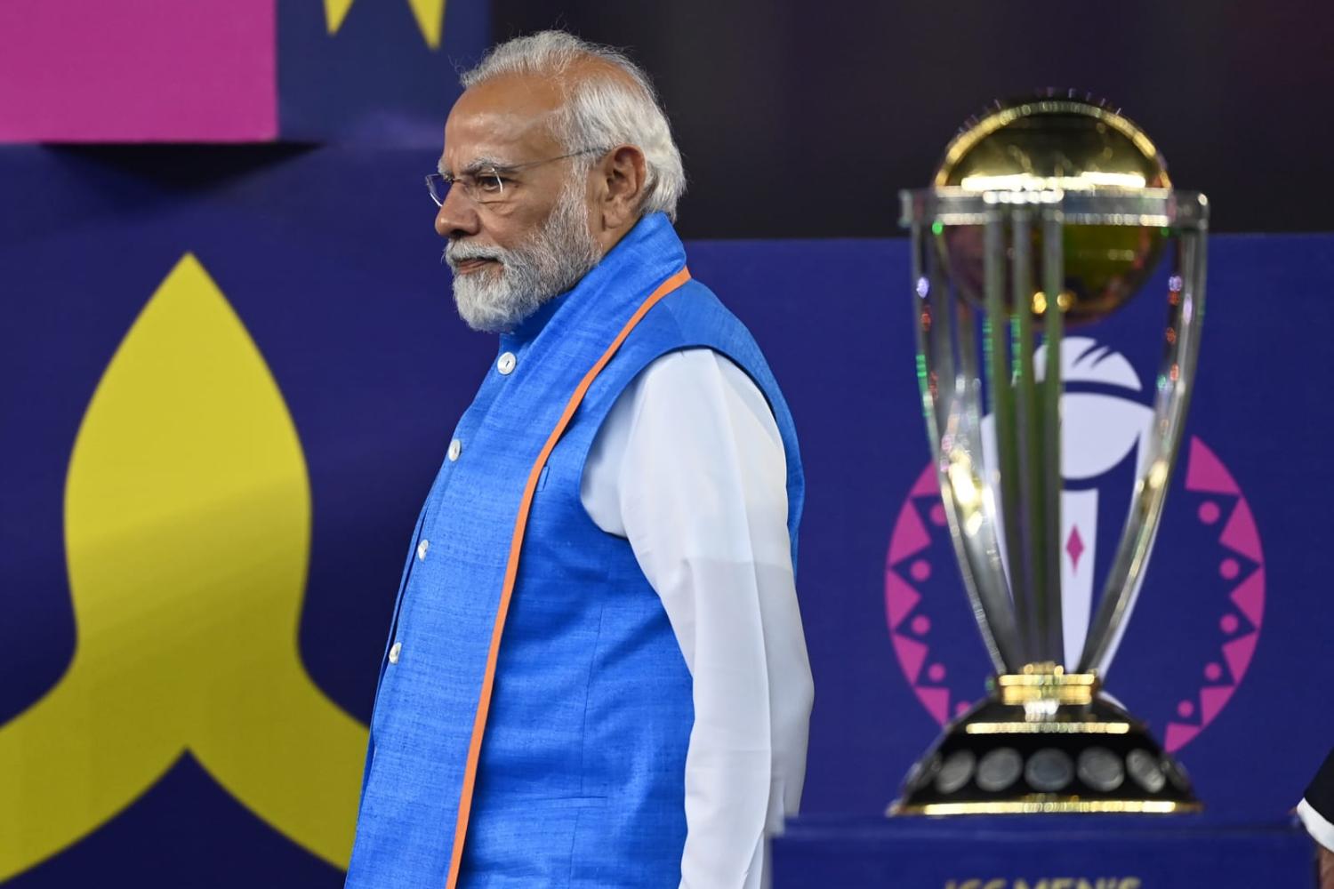 Narendra Modi, India's Prime Minister, passes the ICC Men's Cricket World Cup trophy during the presentation at Narendra Modi Stadium on 19 November, Ahmedabad, India (Gareth Copley/Getty Images)