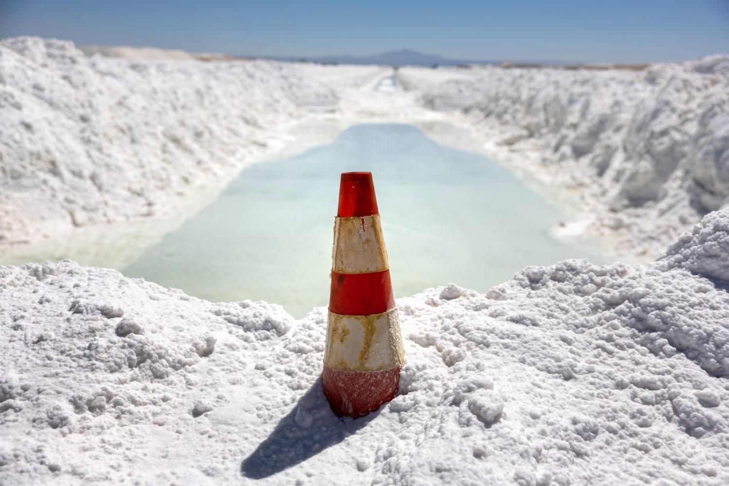 Lithium-rich brine dries in an evaporation pond next to mounds of salt bi-product (John Moore/Getty Images)