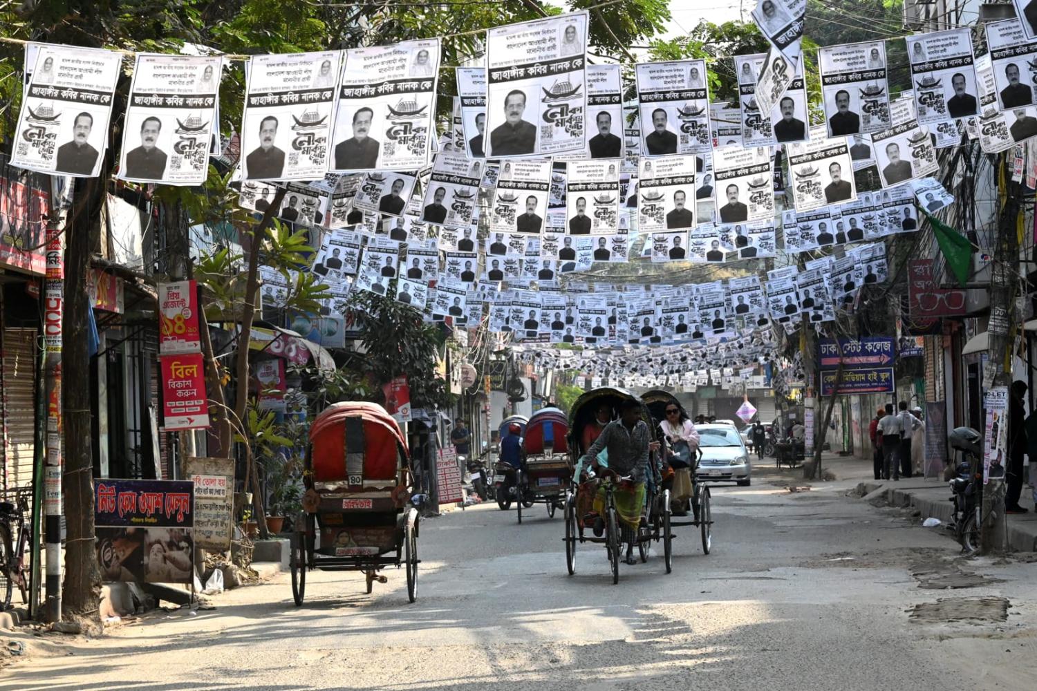 Posters of the ruling Awami League candidates hang over a Dhaka street ahead of the 7 January general election (Mamunur Rashid/NurPhoto via Getty Images)