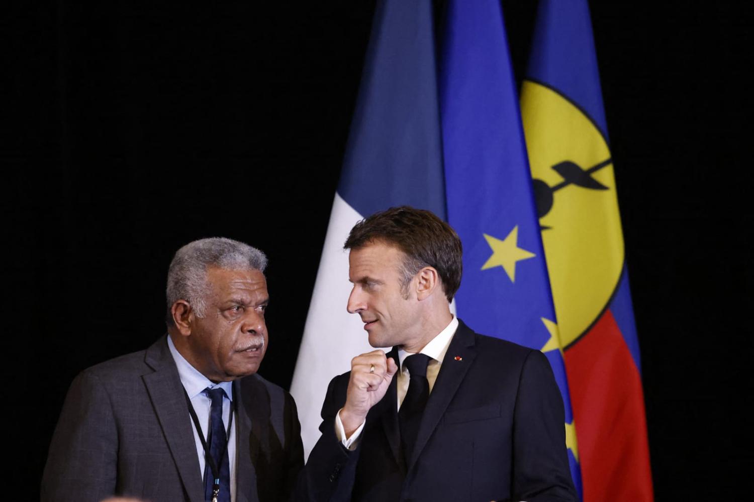 New Caledonia President of the governement Louis Mapou speaks with French President Emmanuel Macron in Port Moresby on 28 July 2023 (Ludovic Marin/AFP via Getty Images)