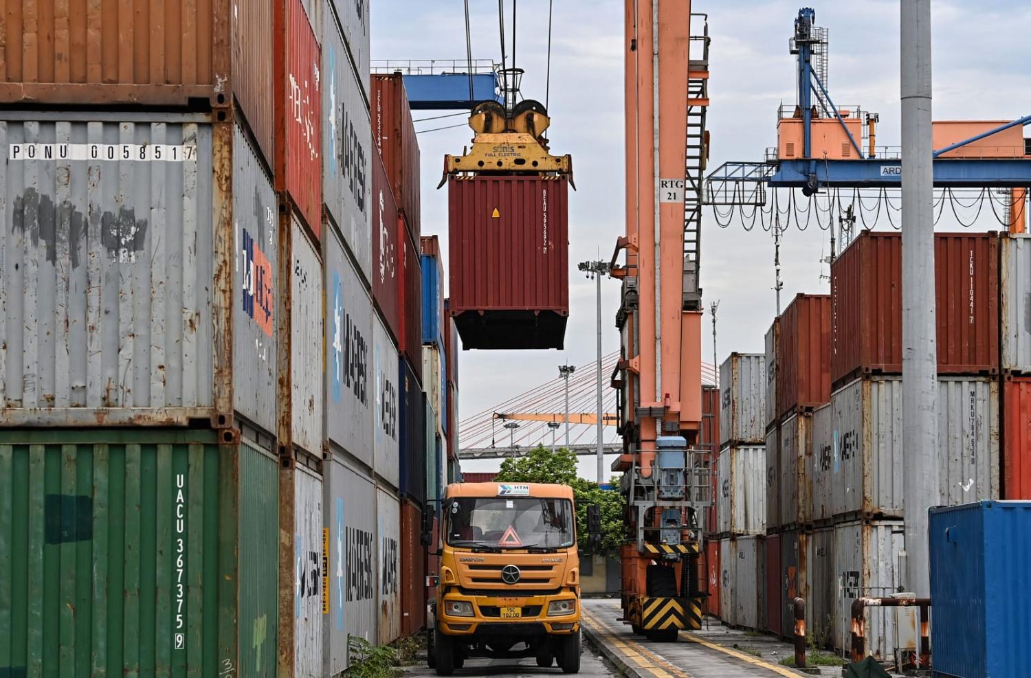 A forklift lifts a container at Tan Vu port in Hai Phong near Hanoi (Photo by Nhac Nguyen/AFP via Getty Images)