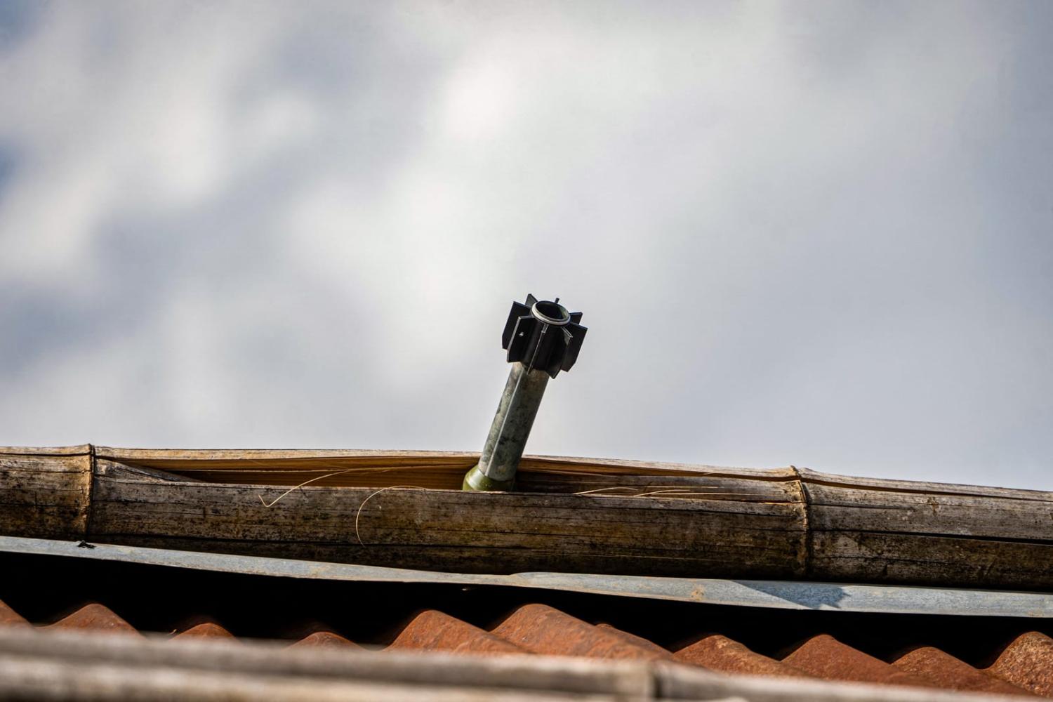 An unexploded projectile stuck on the roof of a house following fighting between Myanmar's military and the Kachin Independence Army in Nam Hpat Kar, Kutkai township, in Myanmar's northern Shan State (AFP via Getty)