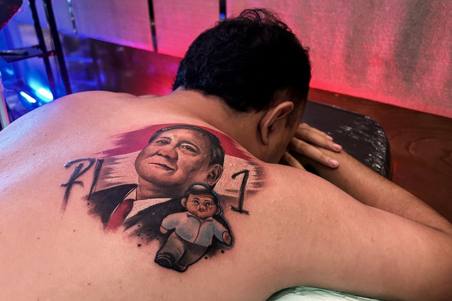 A supporter of Indonesia's Prabowo Subianto has his back tattooed with the now president's image ahead of the 11 January election (Bagus Saragih/AFP via Getty Images)
