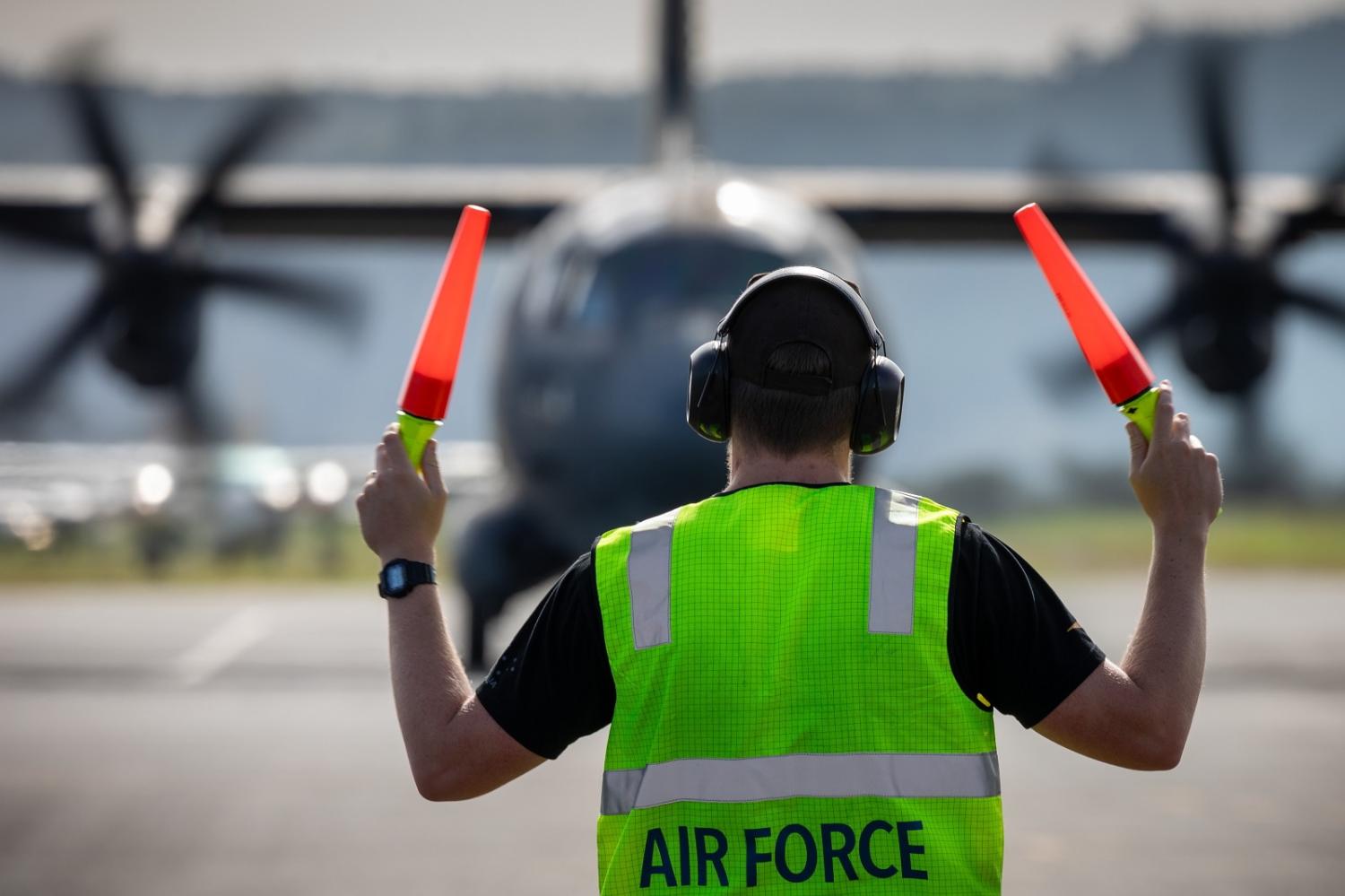 A Royal Australian Air Force Aircraftman marshals a C-27J Spartan aircraft after a surveillance mission out of Port Vila, Vanuatu (David Cotton/Defence Images)