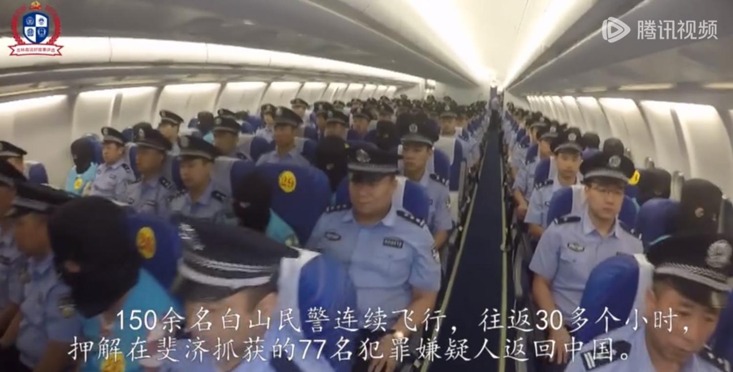 A screenshot of the video distributed on WeChat showing police aboard the airliner
