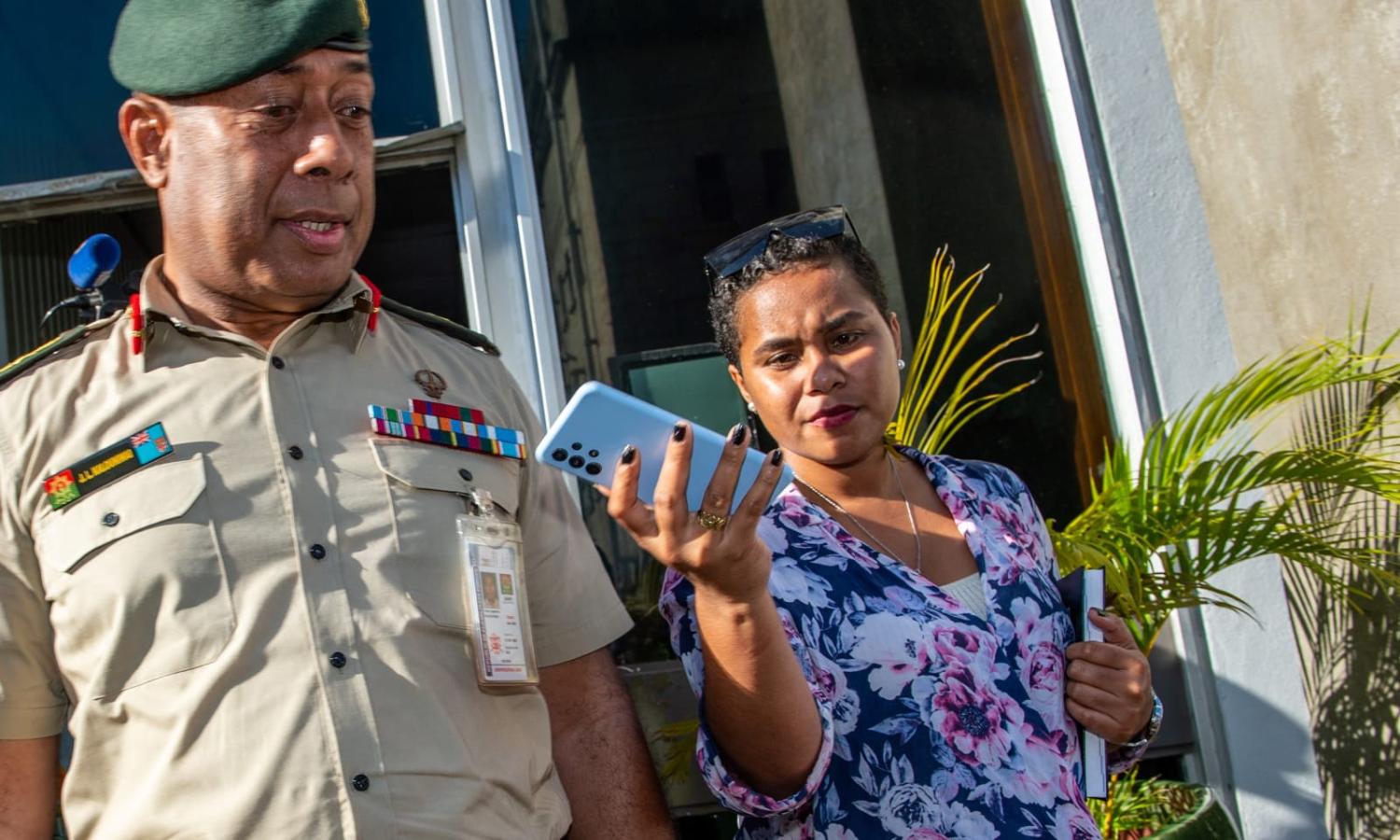 Local reporters quiz a Fijian military commander outside the Prime Minister's office in Suva (Leon Lord/ AFP via Getty Images)