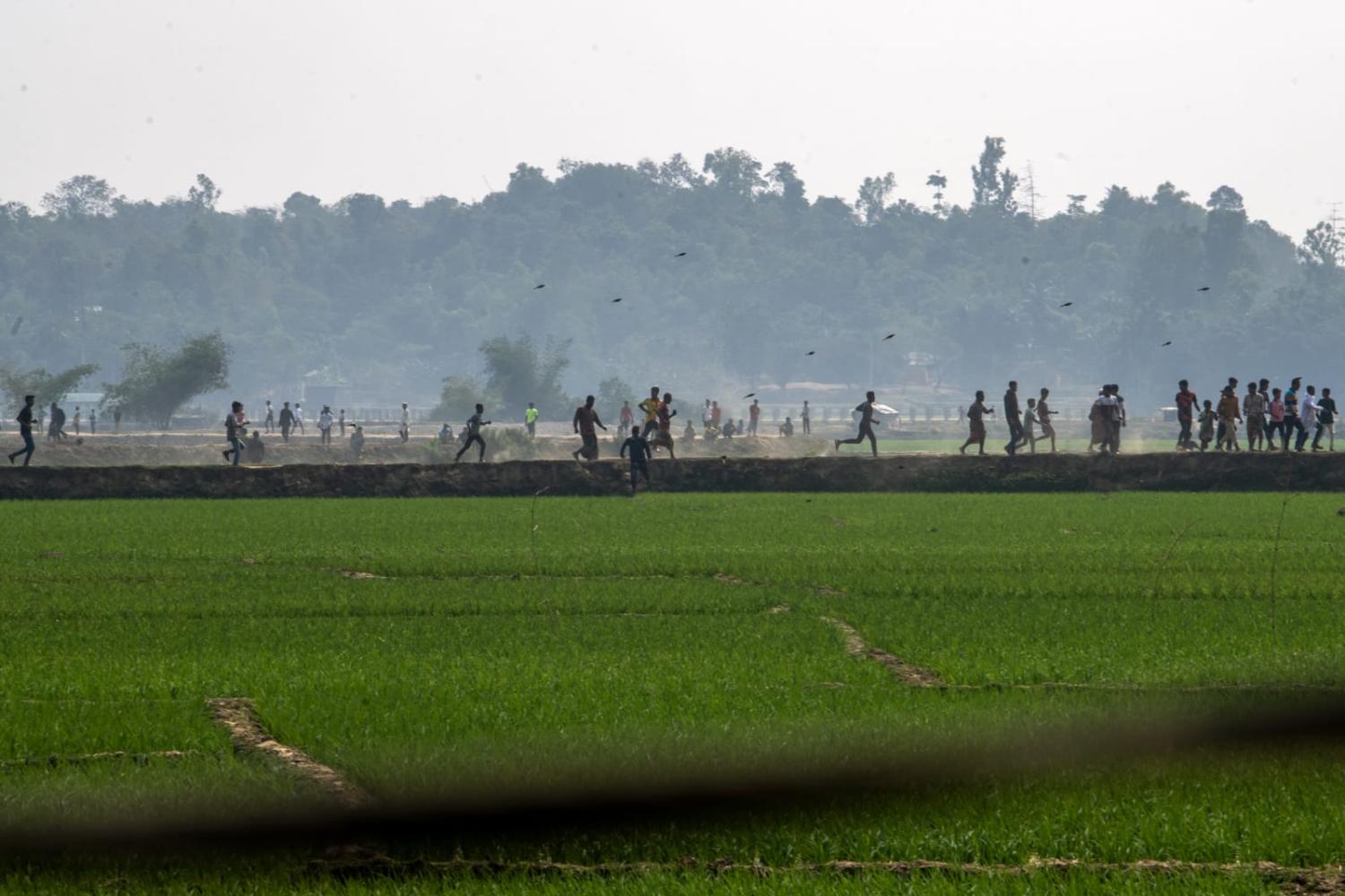 Villagers flee fighting in February between the Myanmar Border Guard and the Arakan Army near the Bangladesh-Myanmar border in Ukhia, Cox's Bazar district, Bangladesh (Syed Mahamudur Rahman/NurPhoto via Getty Images)