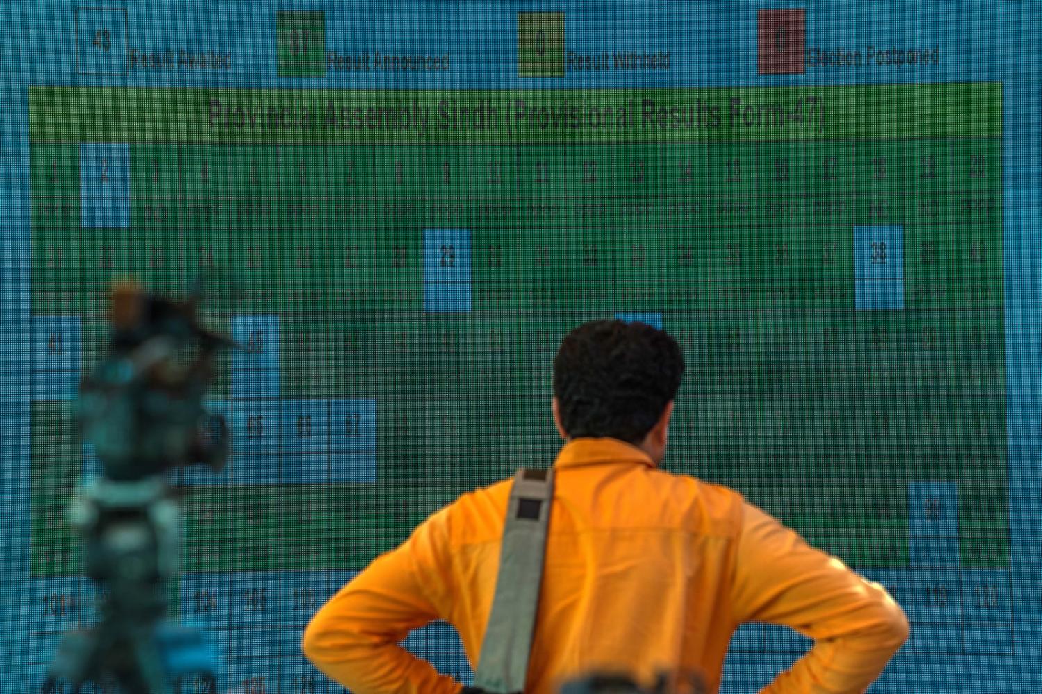 Live election results in Karachi (Hafeez/Bloomberg via Getty Images)