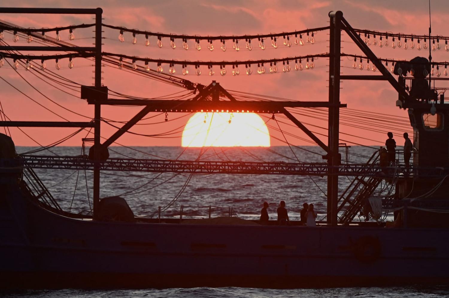 A vessel identified by the Philippine Coast Guard as “Chinese maritime militia” during sunrise in the disputed South China Sea (Jam Sta Rosa/AFP via Getty Images)