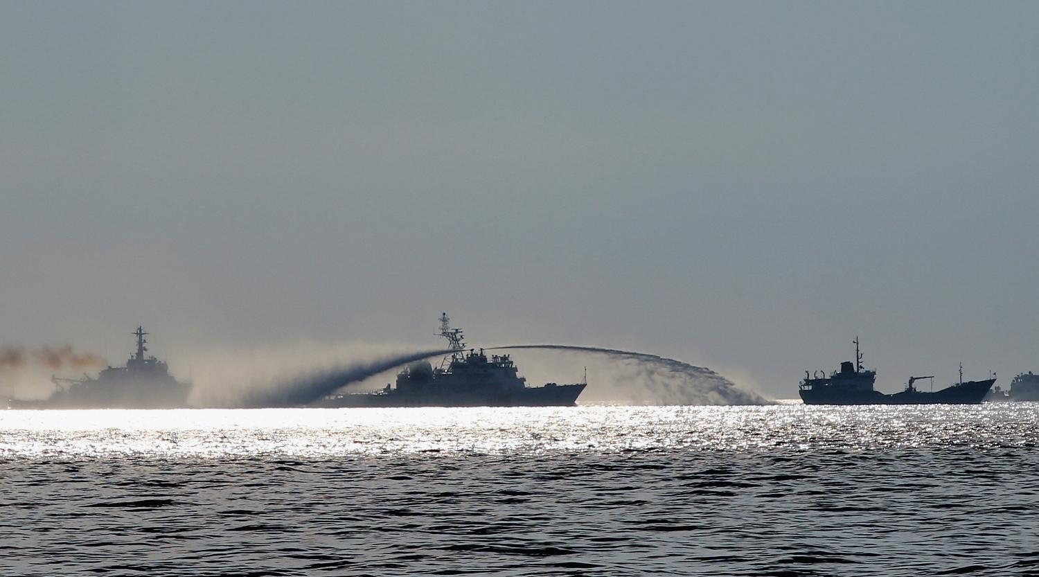 A Chinese Maritime Police Bureau ship uses water canon to harass a Vietnamese fisheries surveillance force vessel near the disputed Paracel Islands in 2014 (Getty/Asahi Shimbun)