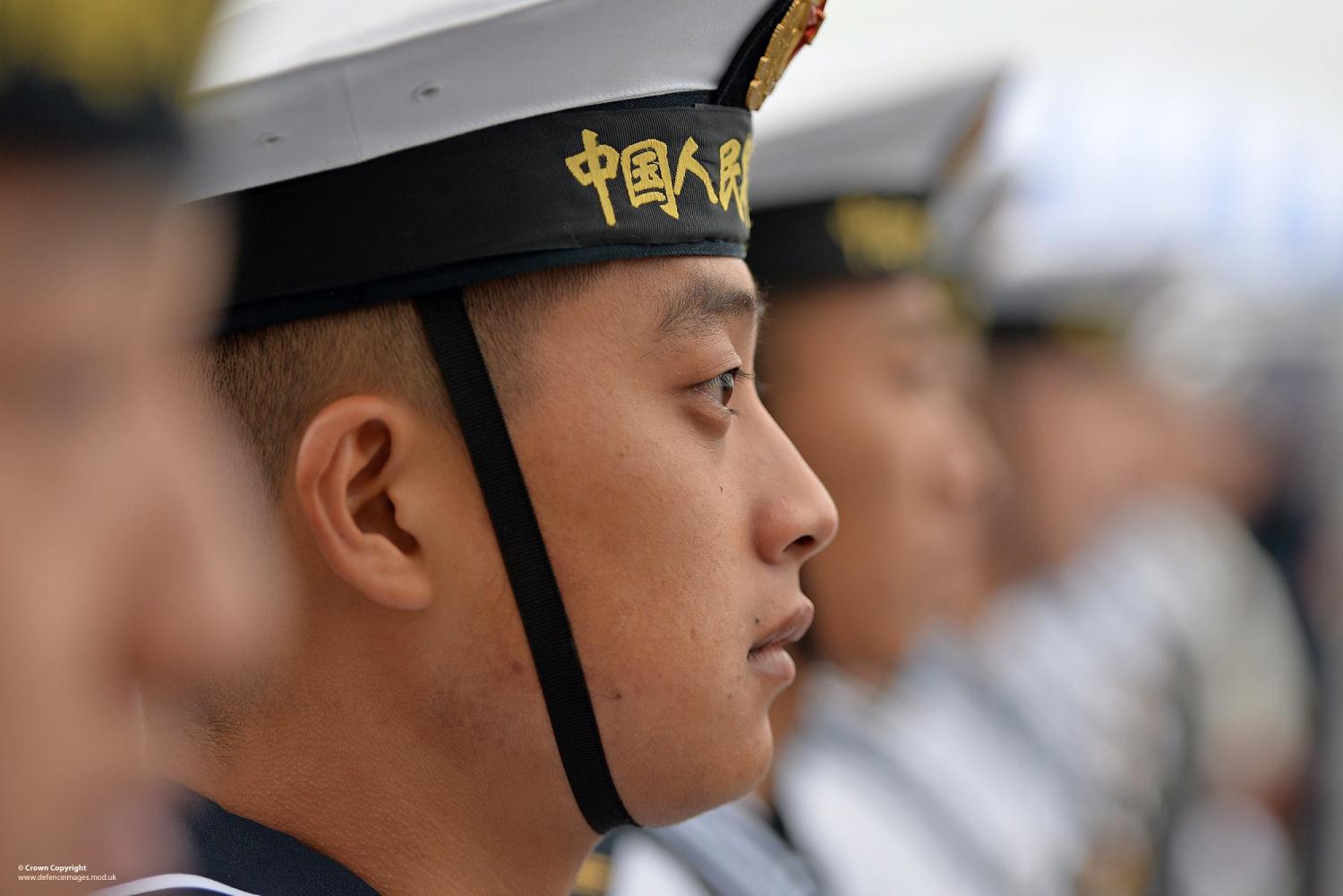 Chinese sailors of the PLA Navy Ship Changbai Shan line the deck as the ship enters Portsmouth for a port visit, January 2015. (Getty/Defence Imagery)