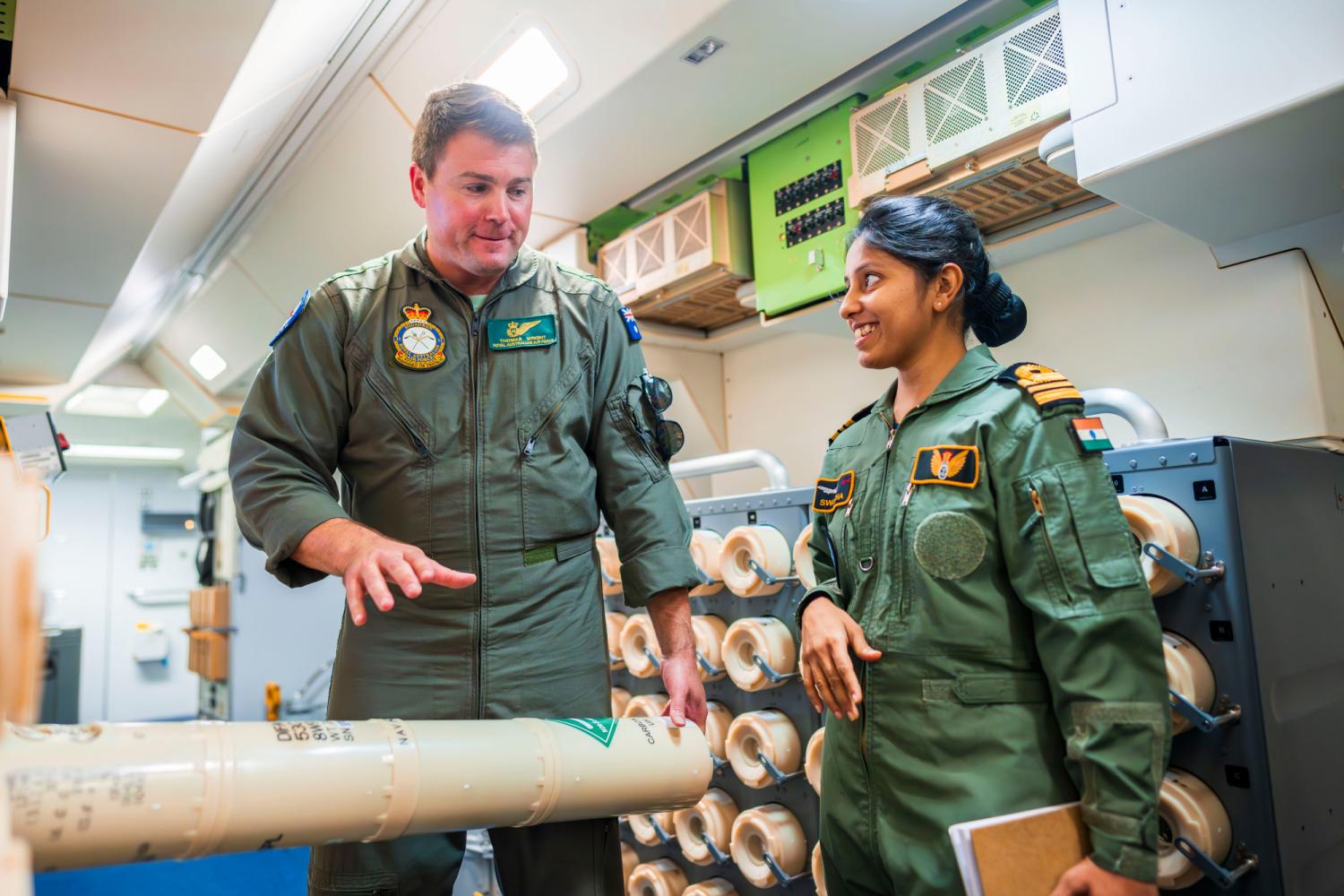 A RAAF officer speaks with an Indian counterpart about the sonobuoys aboard an RAAF P-8A Poseidon at Indian Naval Air Base Rajali during Indo-Pacific Endeavour 23. (Defence/CPL Robert Whitmore)