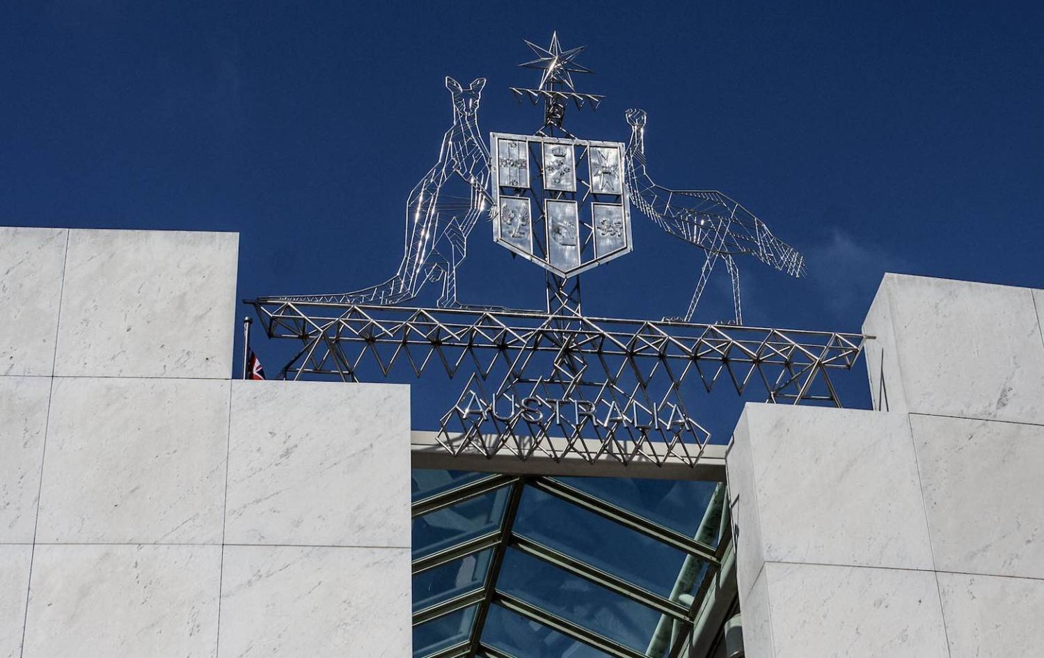 The Australian coat of arms over parliament house, Canberra (John/Flickr)