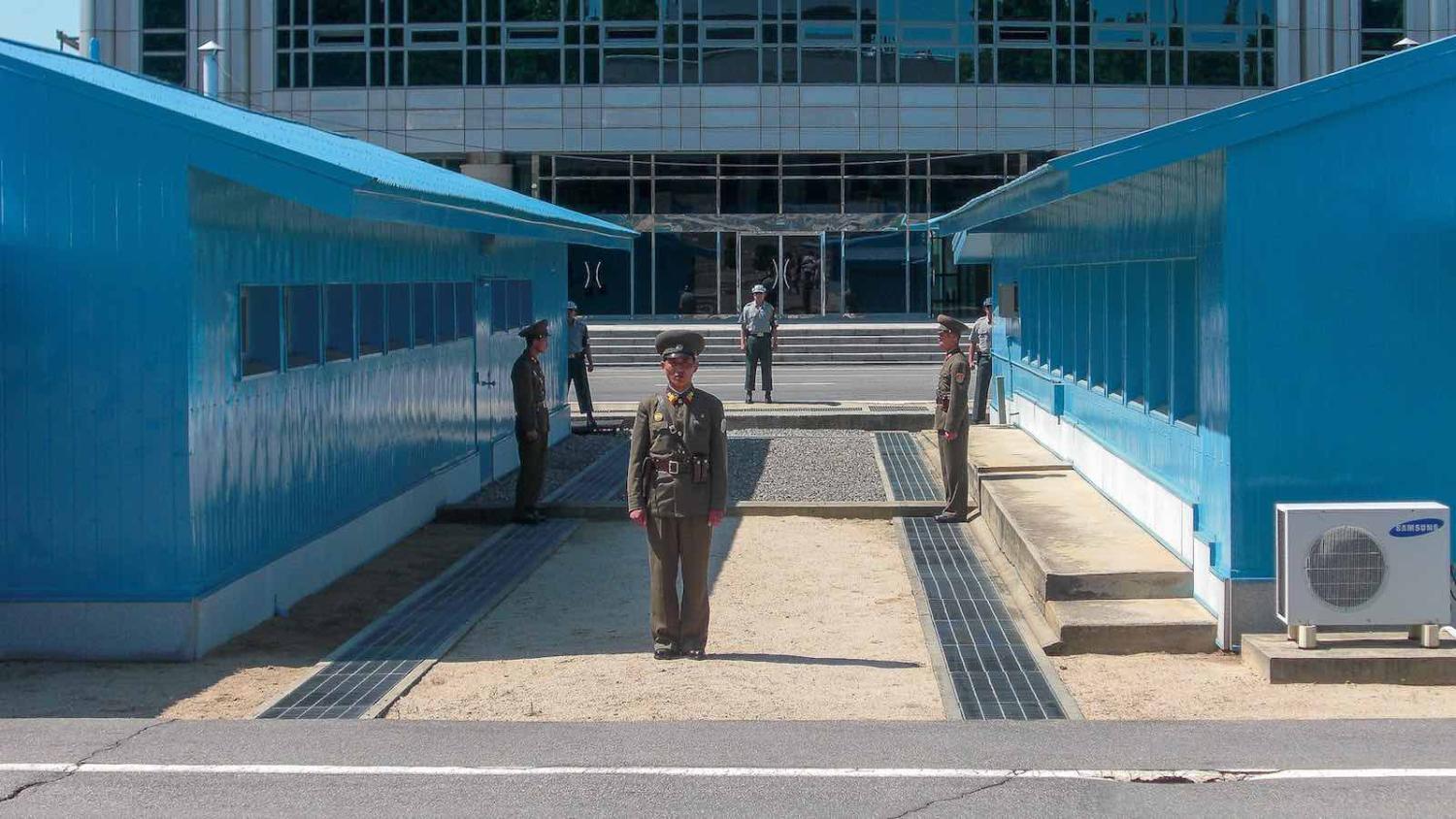 North Korean soldiers stand guard in the DMZ. (Photo: Brodie Karel/Flickr)