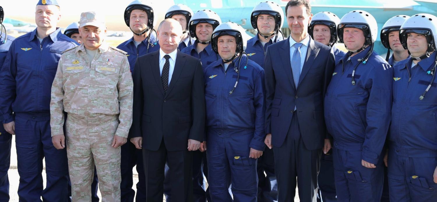 Russia's Vladimir Putin and Syria's Bashar al-Assad with Russian pilots at Khmeimim Air Base in Syria, December 2017 (Photo: kremlin.ru)