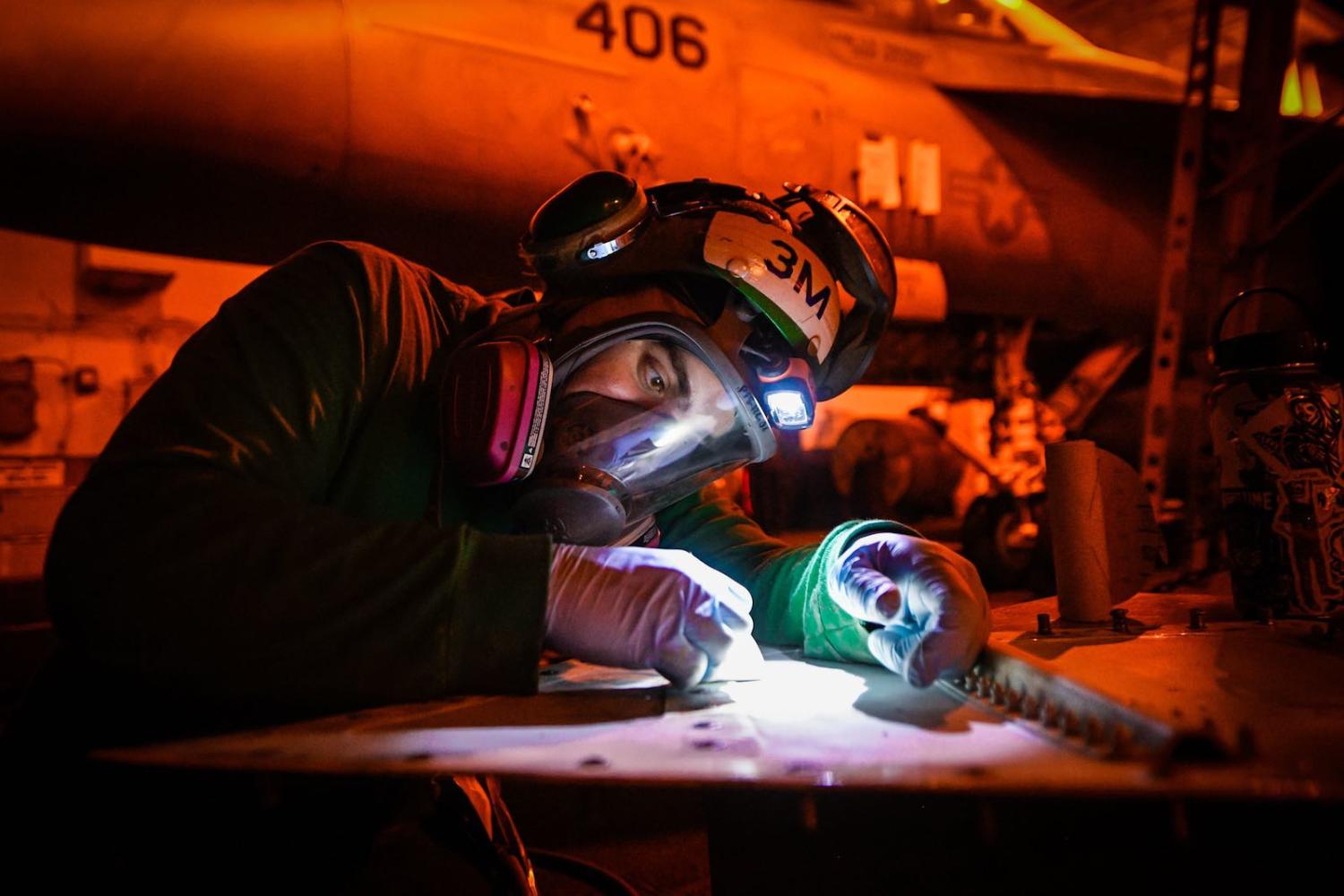 Maintenance work aboard the aircraft carrier USS Theodore Roosevelt in March, the ship now at the centre of a Covid-19 outbreak (US Pacific Fleet/Flickr) 