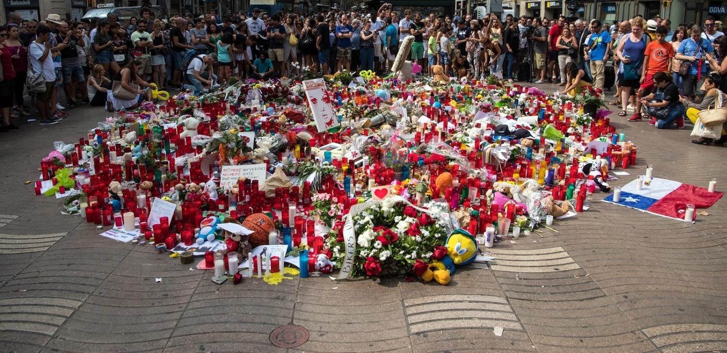 People gather around tributes on Las Ramblas near the scene of Thursday's terrorist attack in Barcelona. (Photo:Carl Court/Getty Images)