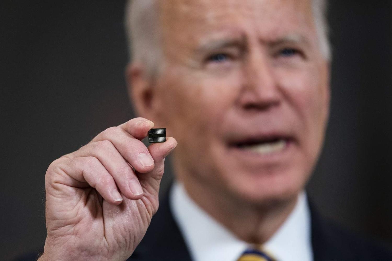 President Joe Biden holds a semiconductor during his remarks before signing an Executive Order on the economy at the White House, 24 February 2021 (Doug Mills/Pool/Getty Images)