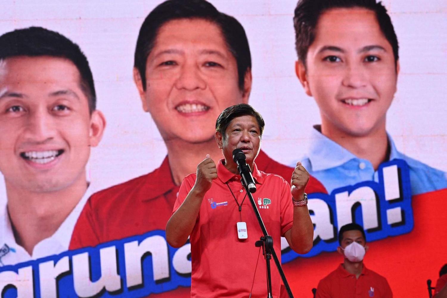 Presidential candidate Bongbong Marcos introduces his son Ferdinand Alexander “Sandro” Marcos during a rally in Laoag City, Ilocos Norte province, 25 March 2022 (Ted Aljibe/AFP via Getty Images)