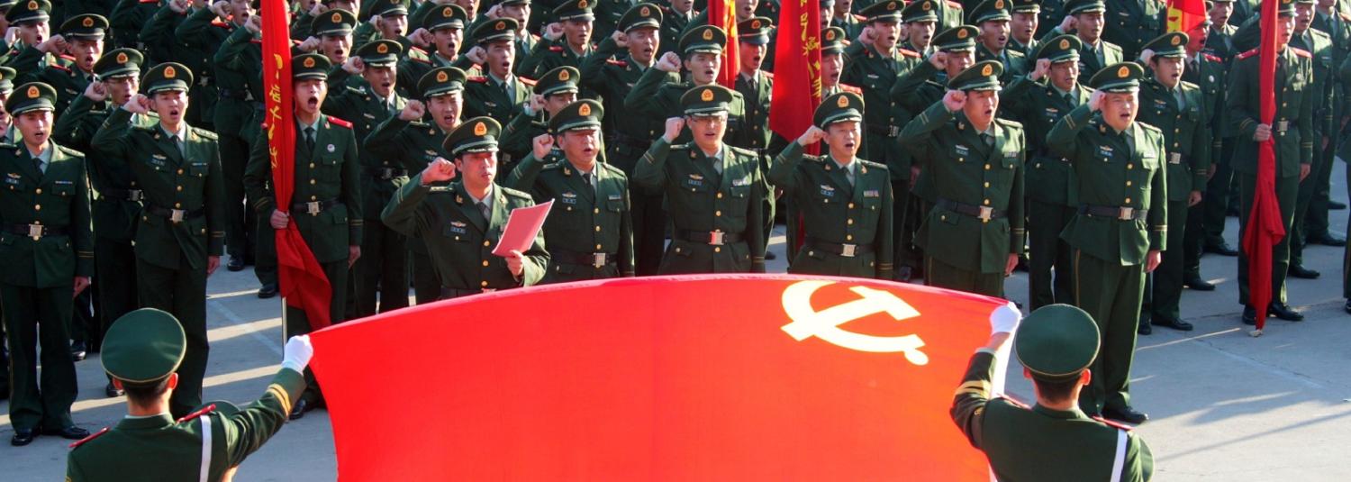 Soldiers saluting the Chinese Communist Party flag in Beijing (Photo:Getty Images)