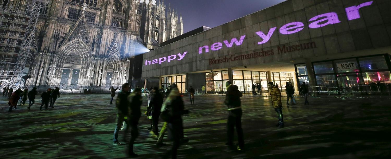Visitors celebrate New Year's Eve in front of Cologne Cathedral, Germany (Photo by Maja Hitij/Getty Images)