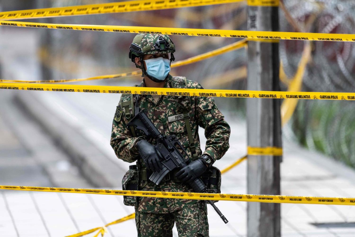 A soldier in Kuala Lumpur guarding a cordoned-off area (Mohd Rasfan/AFP/Getty Images)