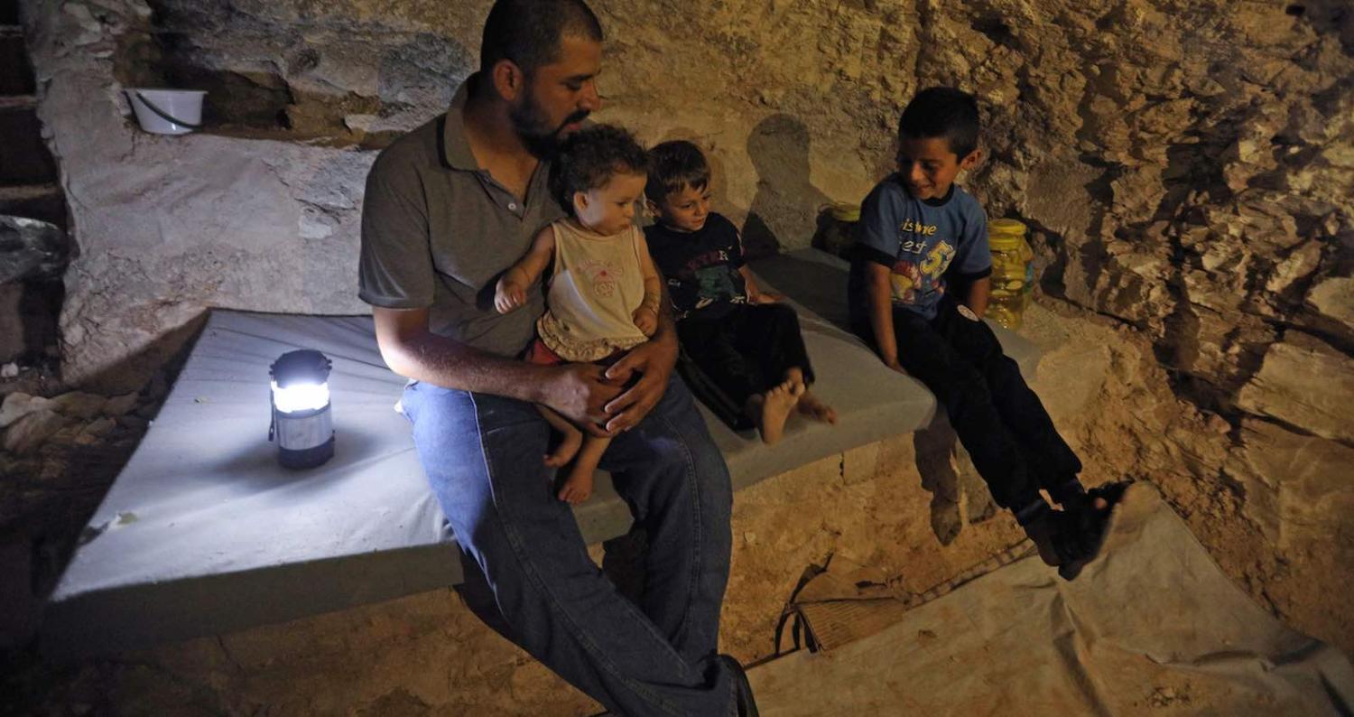 A family in an underground bunker, preparing for strikes in Idlib province, Syria (`Photo: Omar Haj Kadour via Getty)