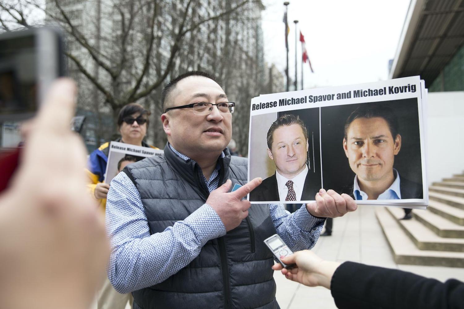 A demonstration in support of Canadians Michael Spavor and Michael Kovrig, detained by China, outside court in Vancouver in March 2019 during an appearance by Huawei Chief Financial Officer Meng Wanzhou (Jason Redmond/AFP via Getty Images)