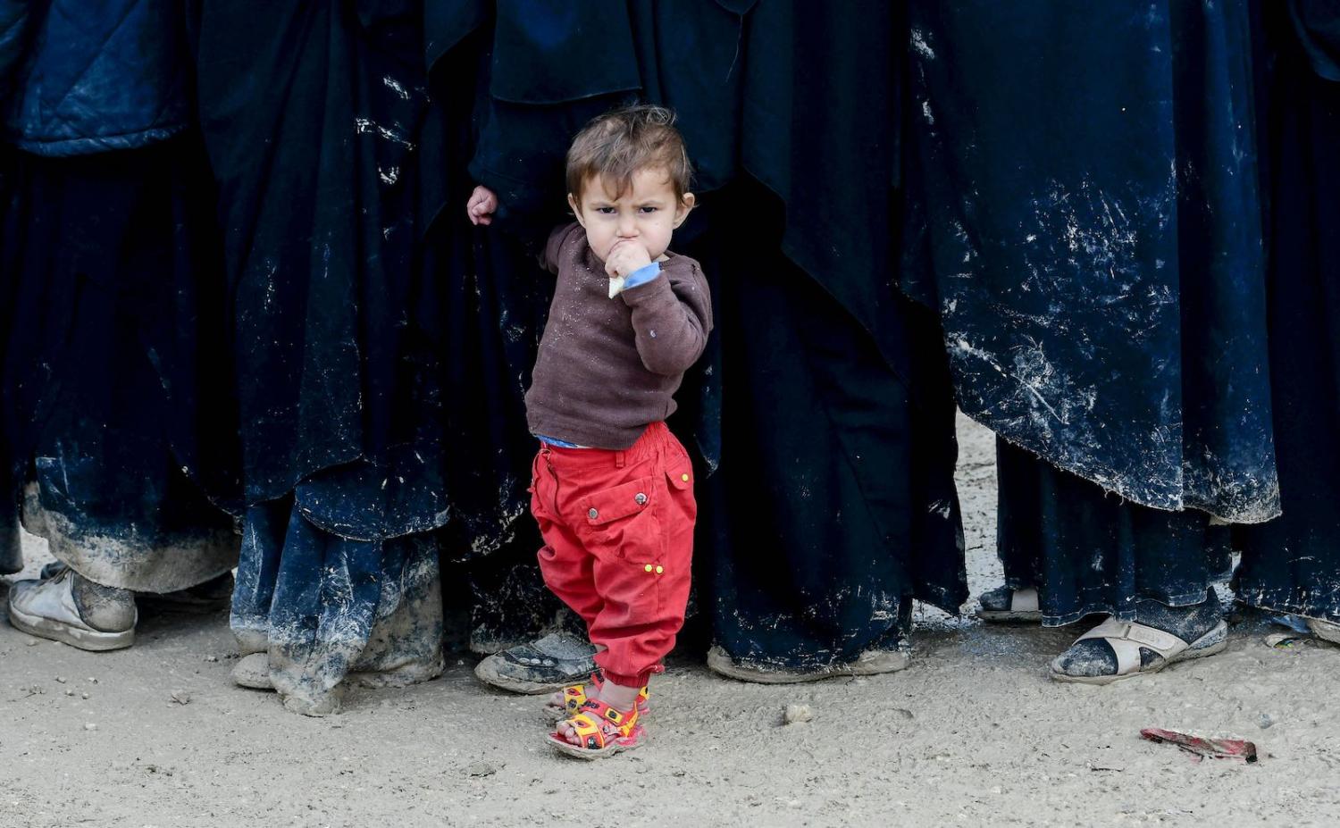 A child stands in queue in al-Hol camp, housing relatives of ISIS members, northeastern Syria (Photo: Giuseppe Cacace via Getty)