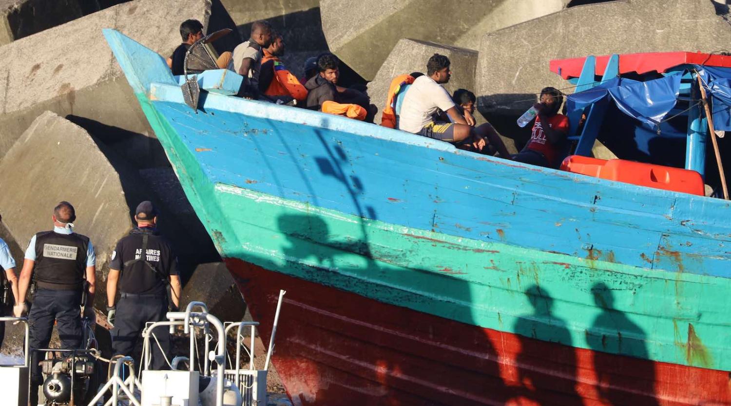 French gendarmes arrive to disembark migrants from a boat on 13 April in Sainte-Rose, on the French Indian ocean island of Réunion (Photo: Richard Bouhet/AFP/Getty Images) 