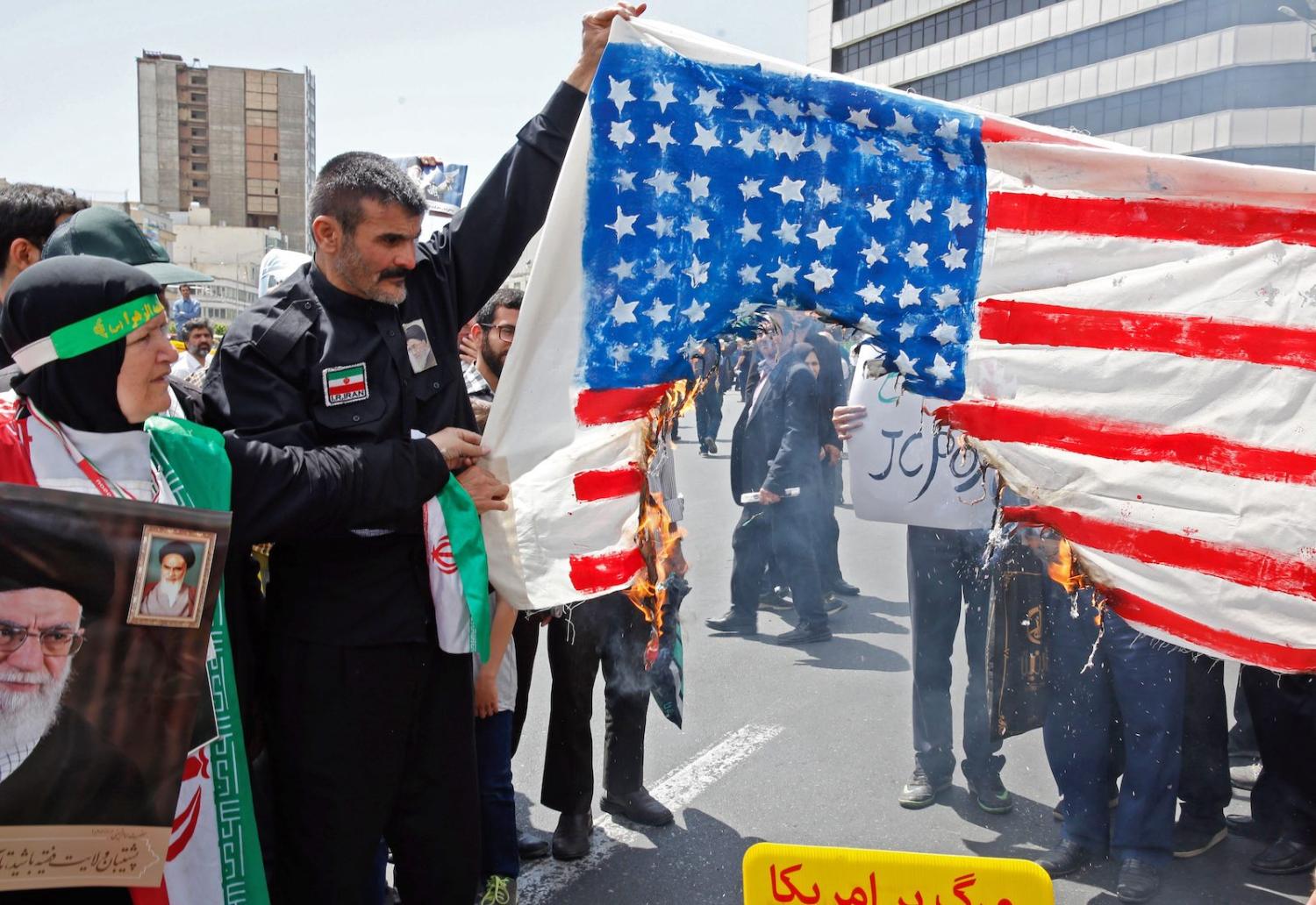 Demonstrators burn a makeshift US flag in Tehran this month (Photo: STR via Getty)