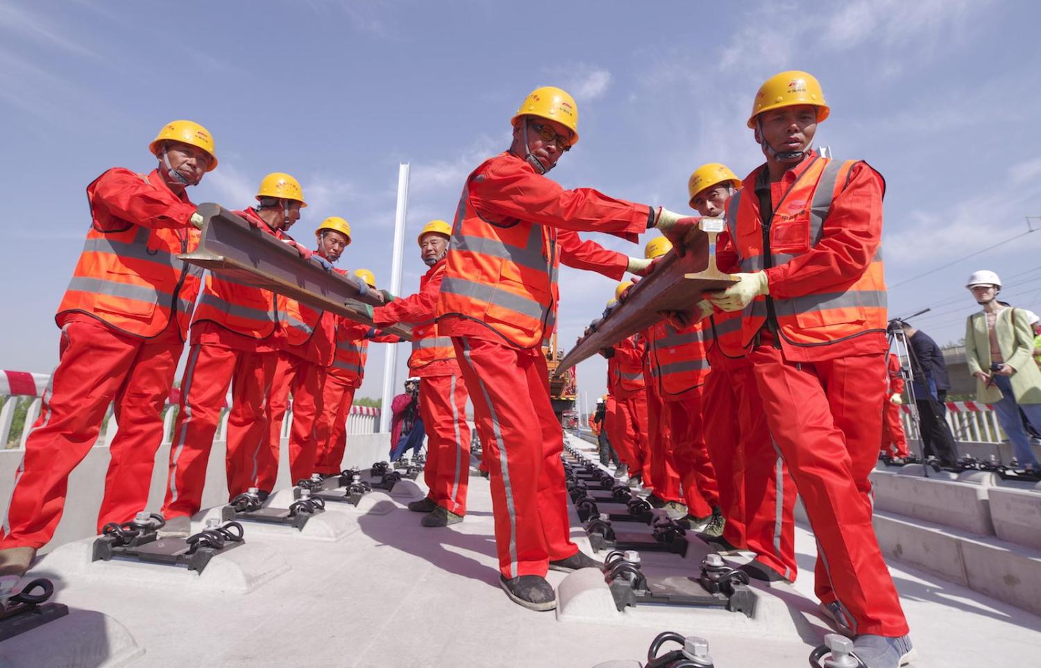 Workers lay rails for the Beijing-Xiong'an Intercity Railway (Photo: Jia Tianyong via Getty)