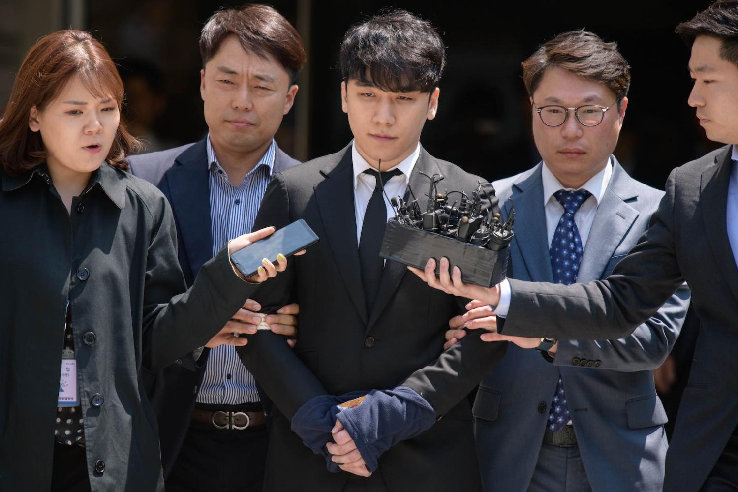 Former Big Bang boyband member Seungri, centre, real name Lee Seung-hyun, leaves the High Court in Seoul in May (Photo: Ed Jones via Getty)