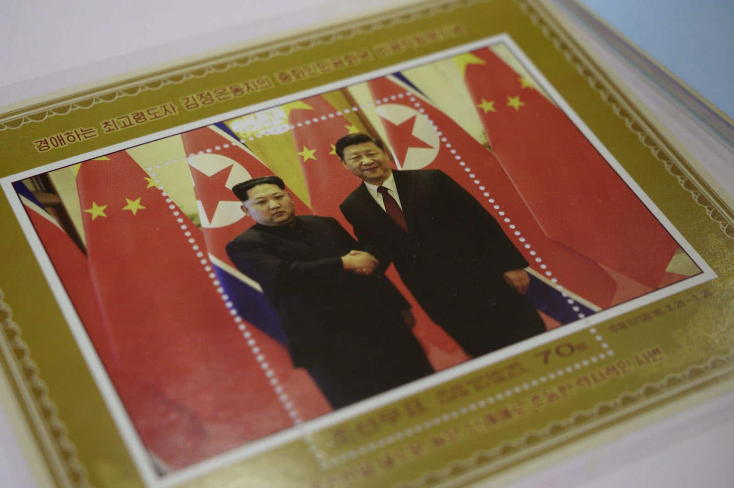 A commemorative stamp featuring North Korean leader Kim Jong-un (left) meeting in 2018 with China’s Xi Jinping (Ed Jones/AFP via Getty Images)